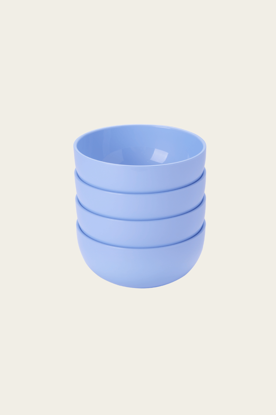 Stack of four light blue ceramic cups on a beige background