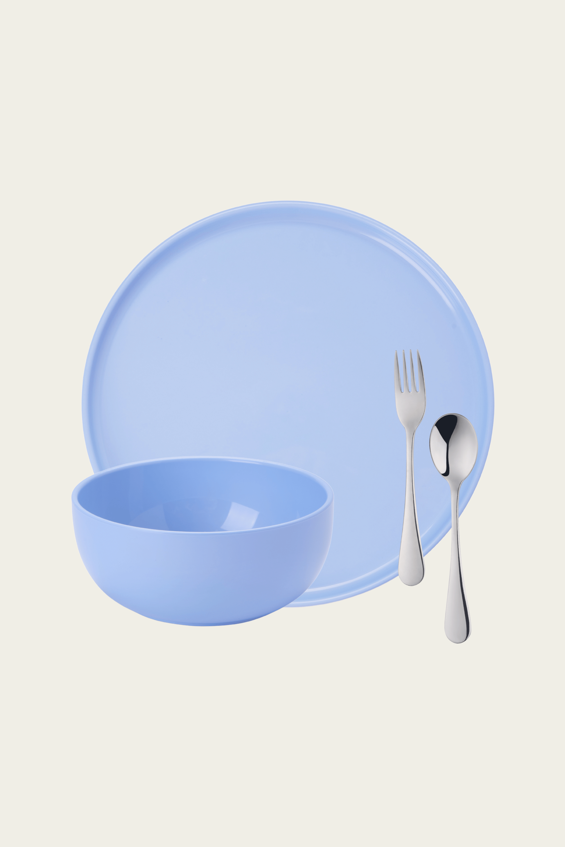 Blue ceramic plate, bowl, fork, and spoon on a beige background