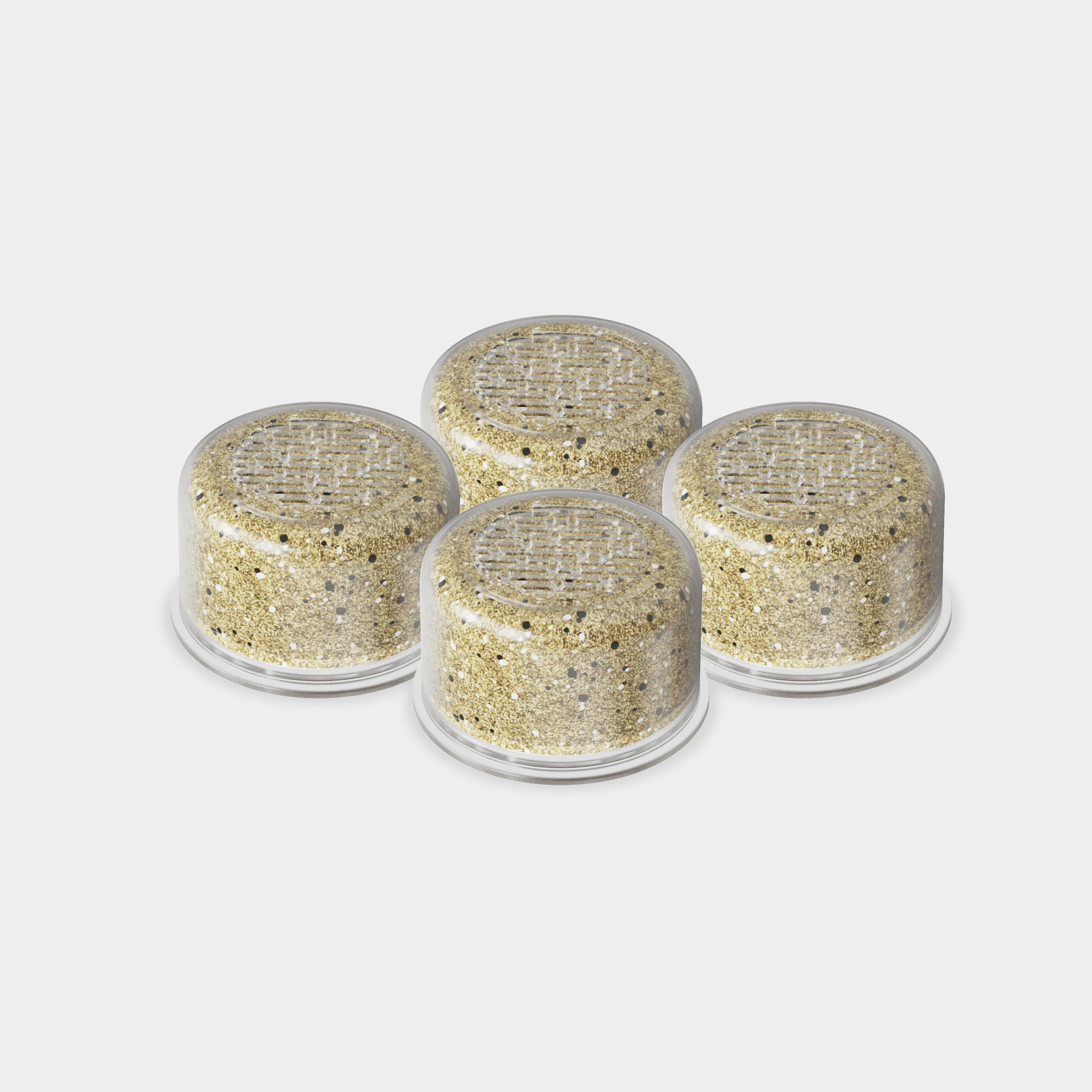 Four round containers with gold glittery substance on a white background