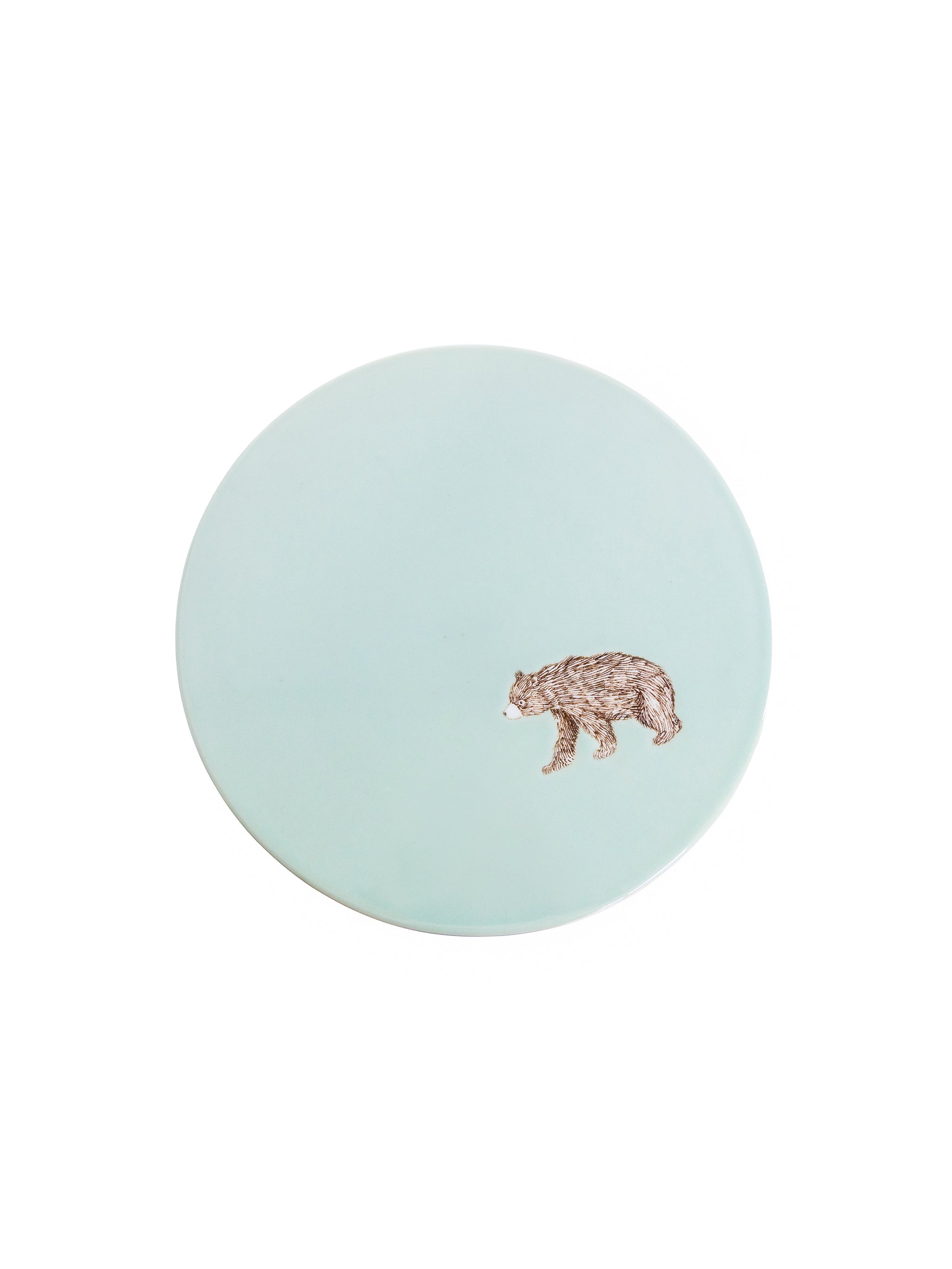 Round light blue coaster with a bear design on a white background