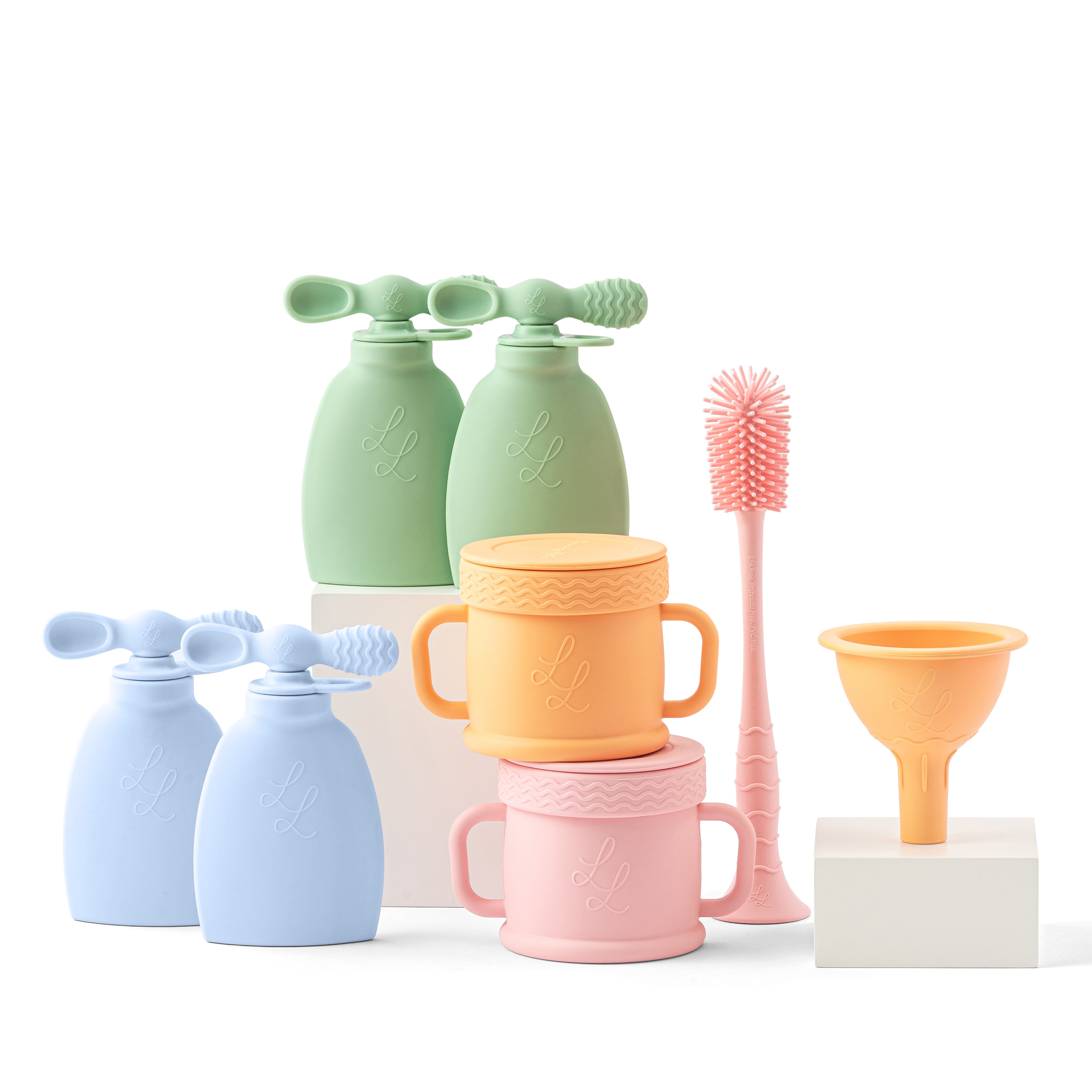 Set of colorful silicone kitchen tools including bottles, cups, and a funnel on a white background.