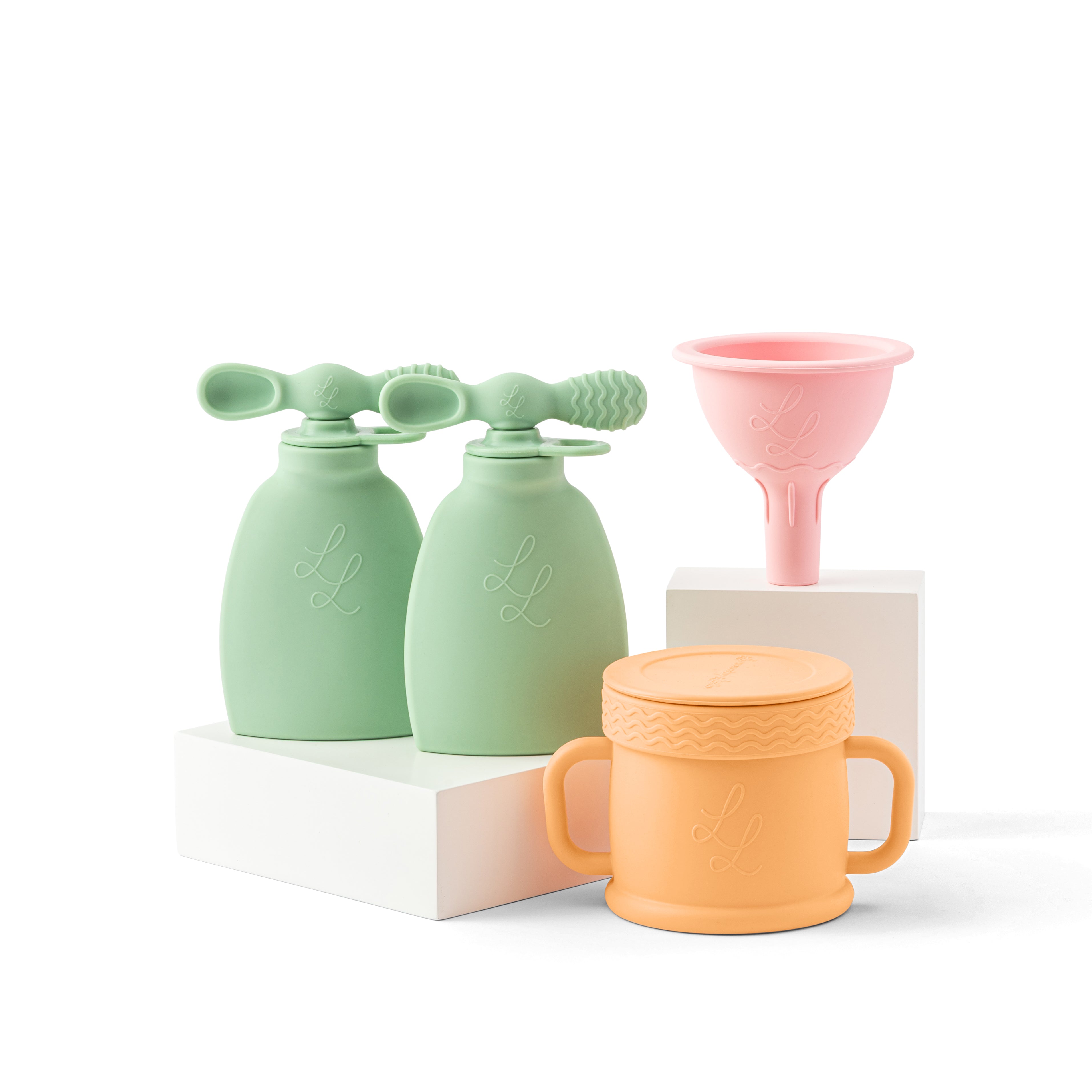 Set of pastel-colored silicone products including a funnel, bottles, and a mug on a white background.
