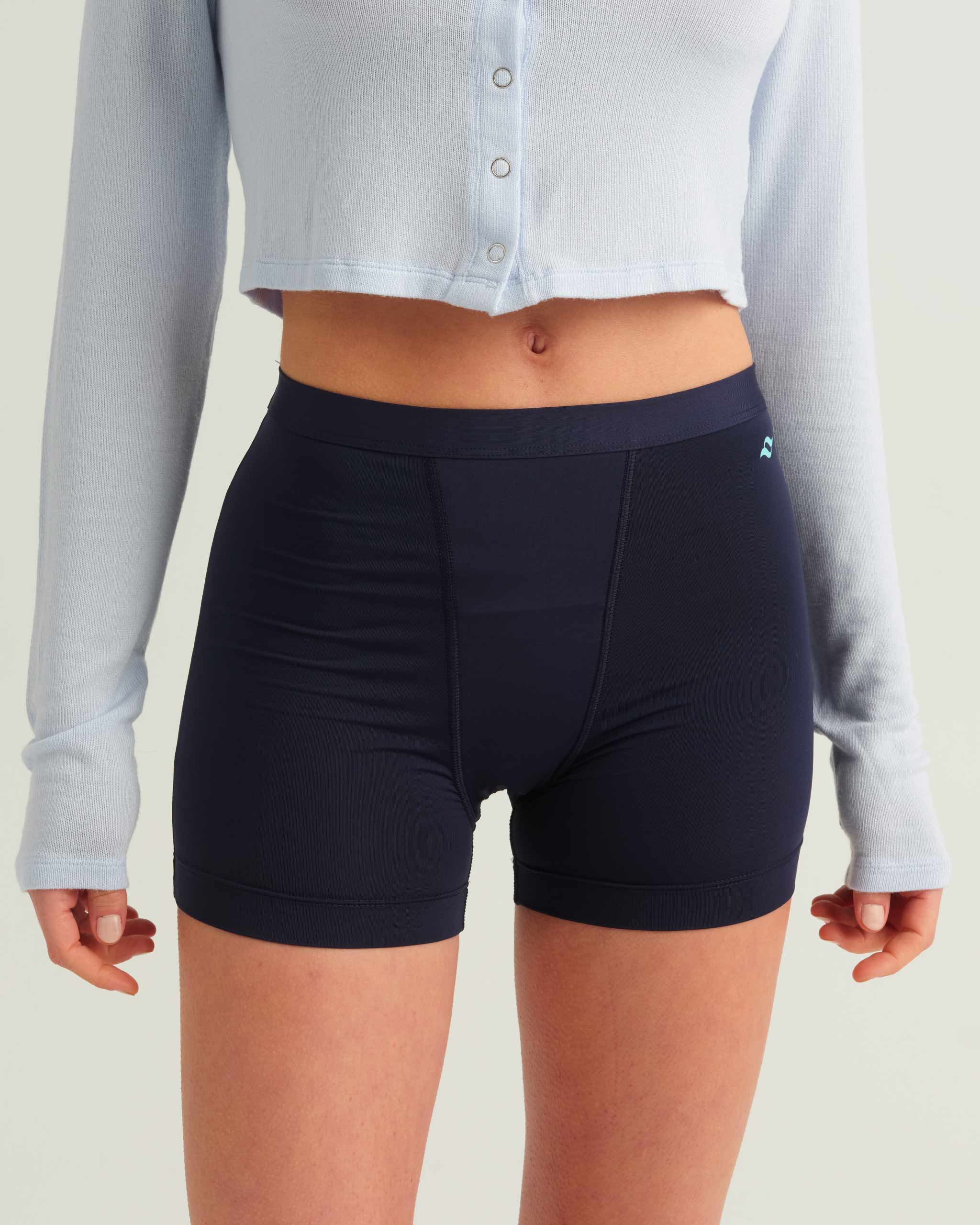 Person wearing navy athletic shorts with a light gray button-up shirt.
