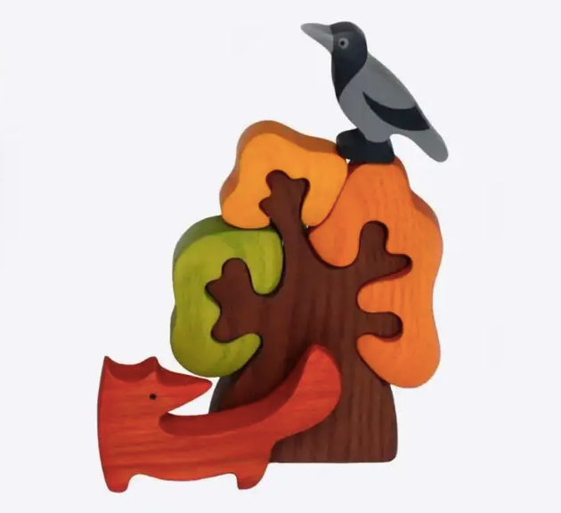 Wooden toy with tree, fox, and bird on a white background