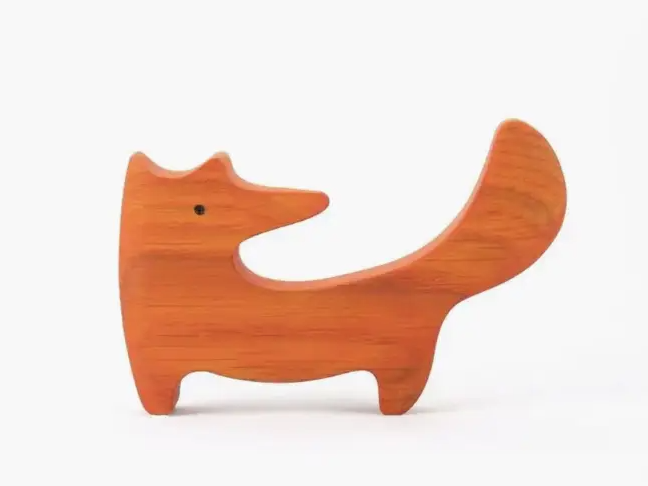Wooden dog-shaped object on a white background