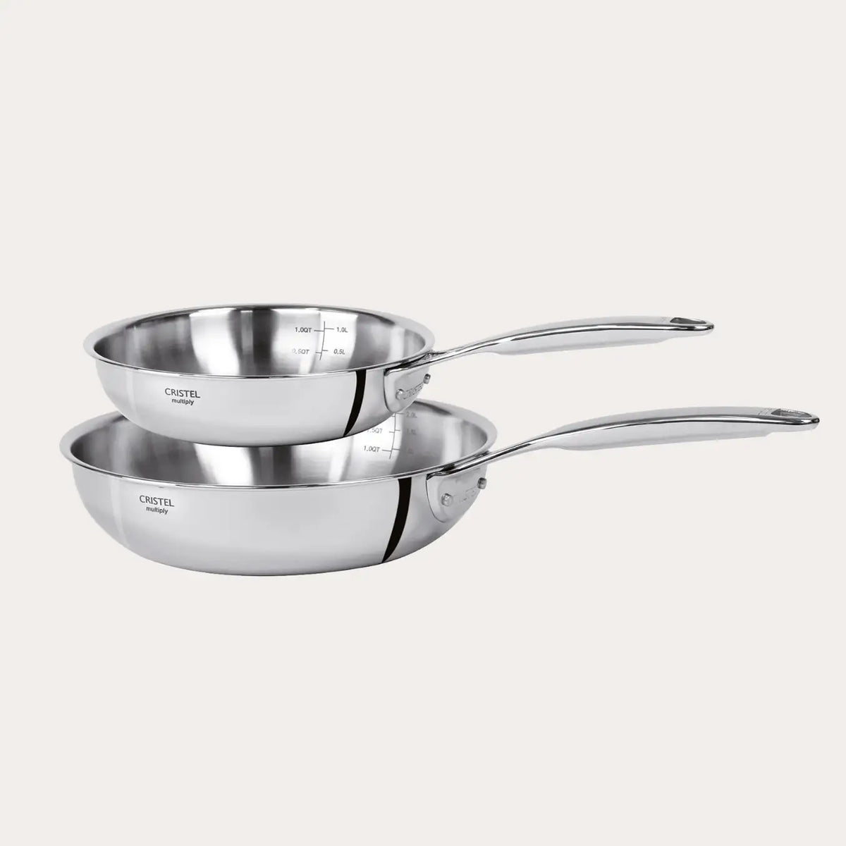Two stainless steel frying pans on a white background