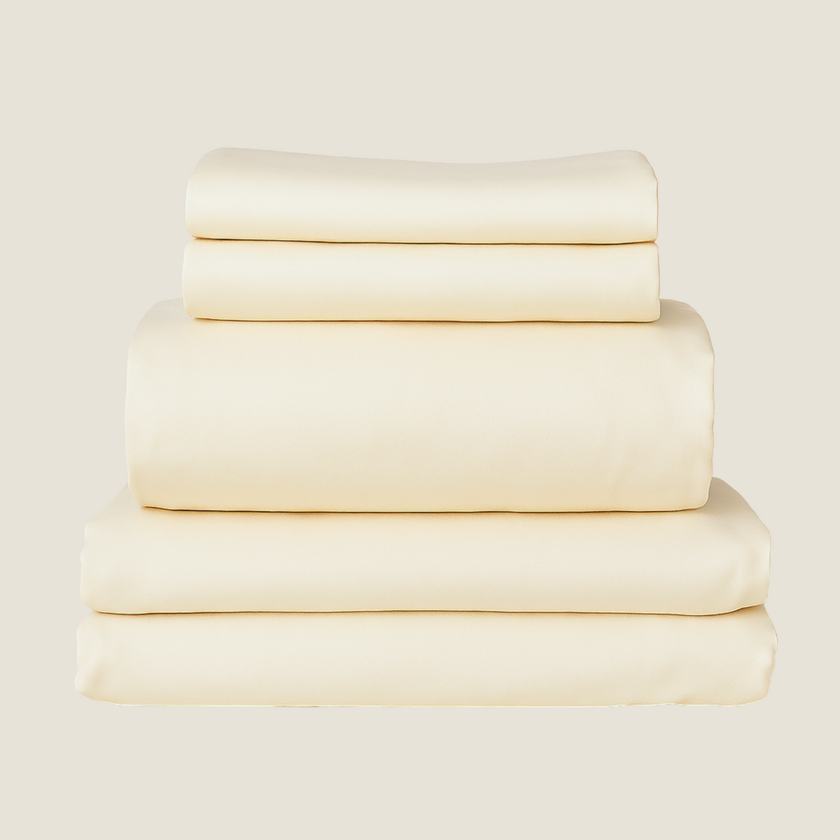 Stack of folded cream-colored bed sheets on a light beige background