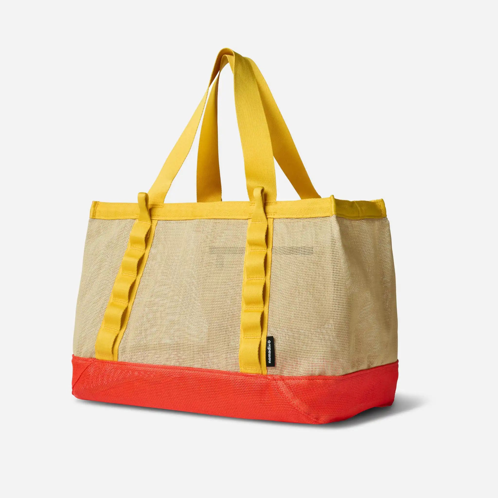 Tote bag with yellow straps and red bottom on a light gray background