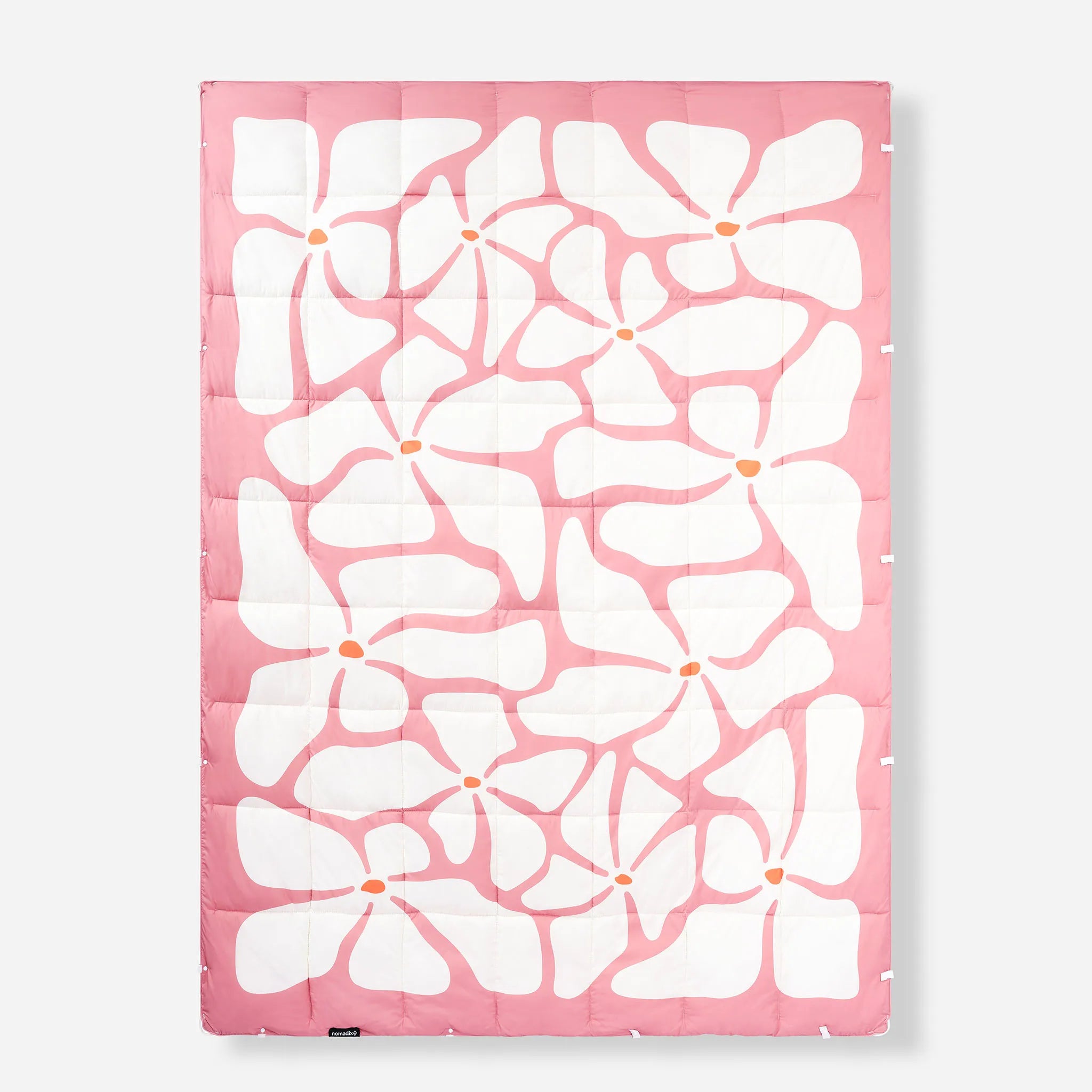A rectangular quilted sleeping pad featuring a bold pink and white floral pattern with small orange centers, shown flat against a light gray background.