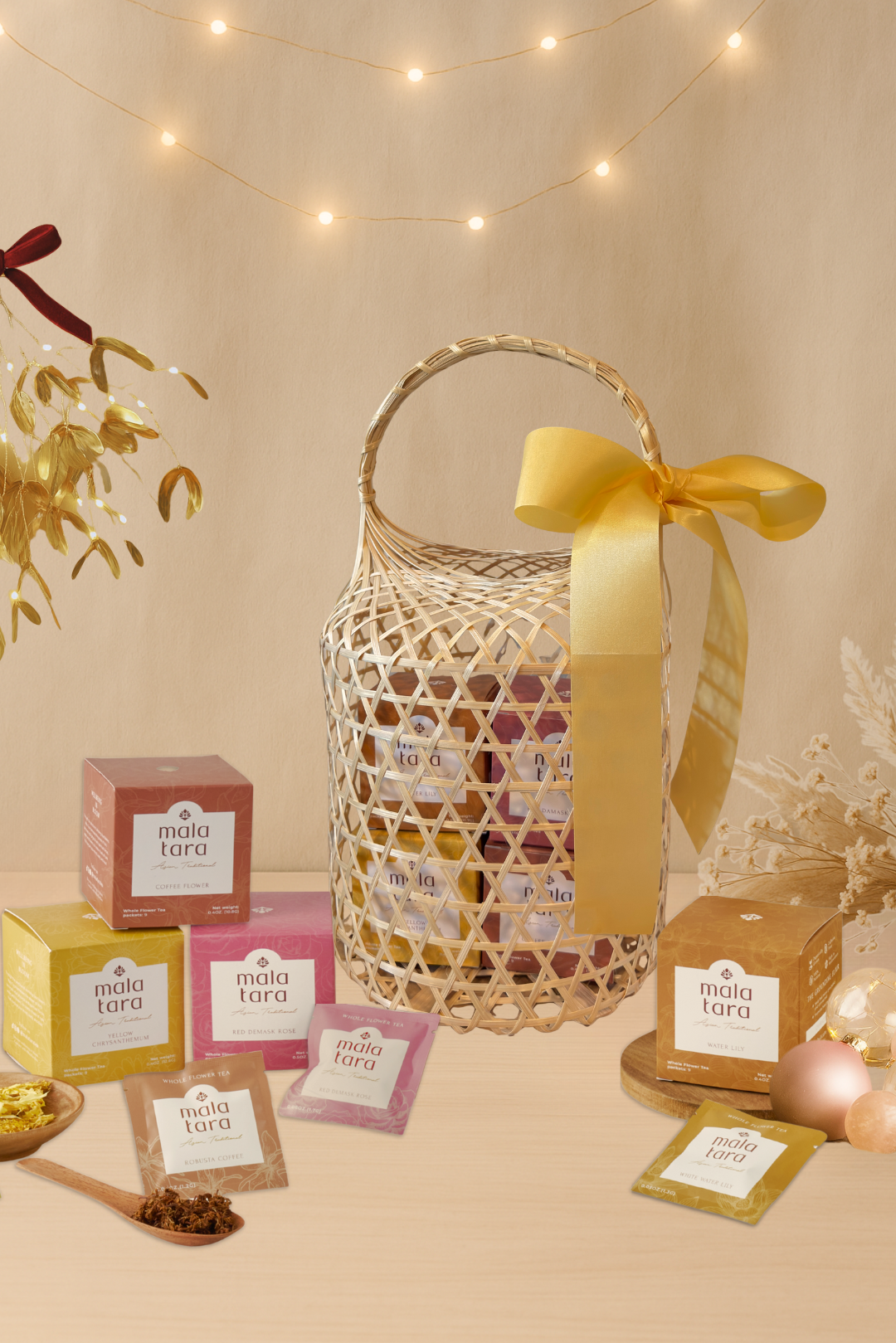 Decorative basket with a yellow ribbon surrounded by tea boxes and packaging on a beige background.