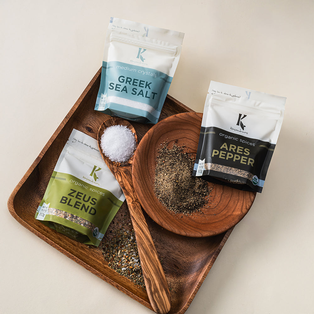 Spice packages on a wooden tray with a neutral background