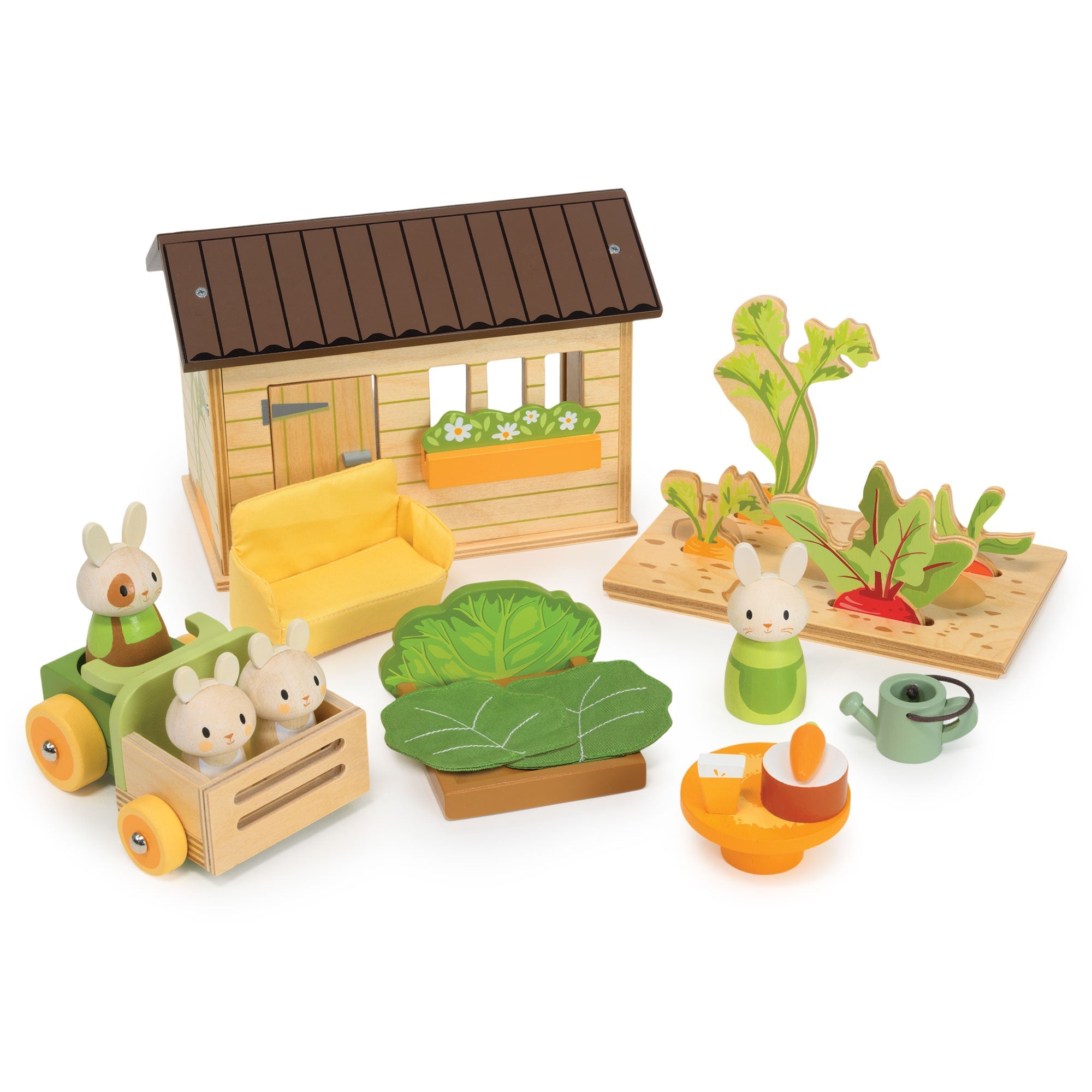 Wooden toy set with a small house, animals, and plants on a white background