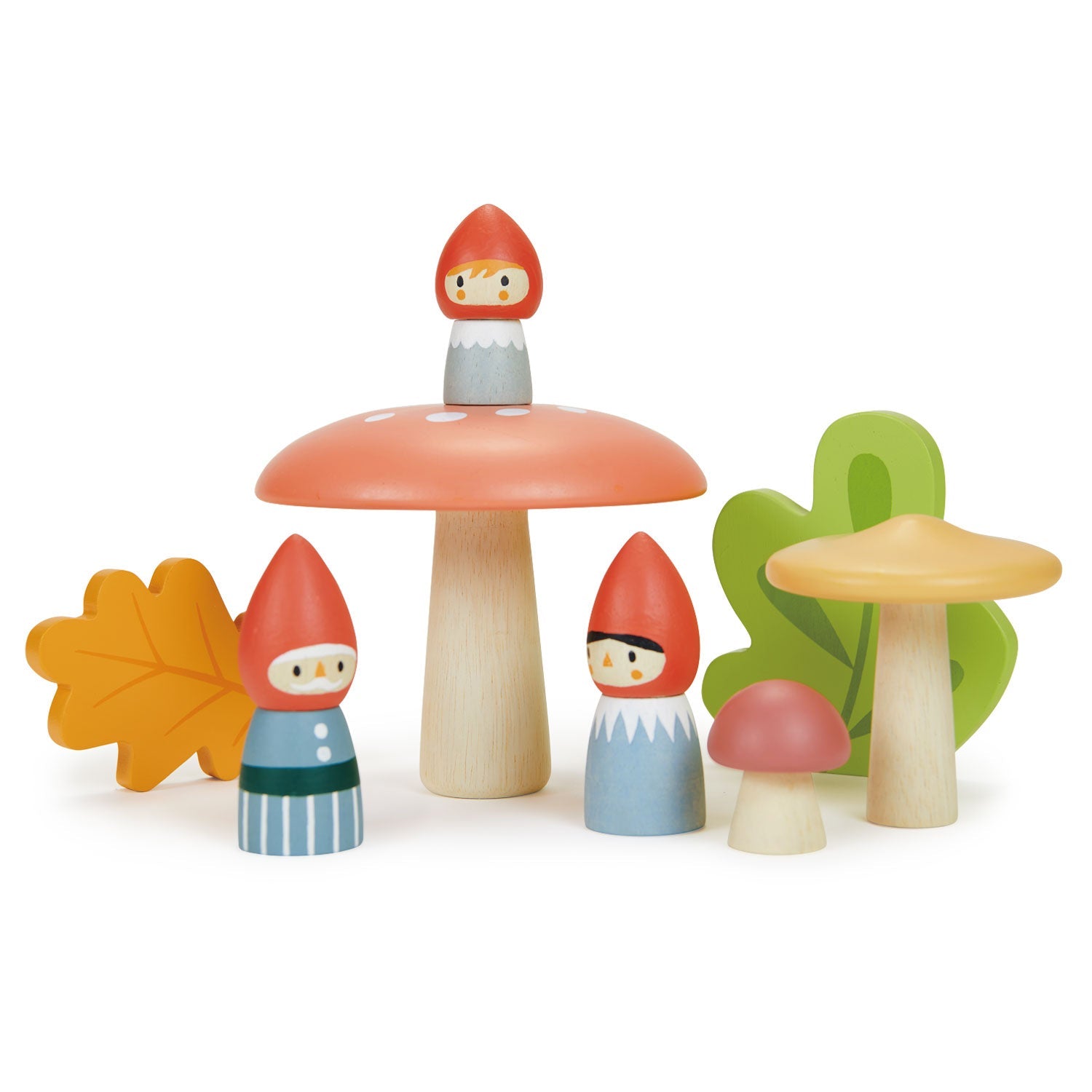 Wooden toy figures of gnomes and mushrooms on a white background
