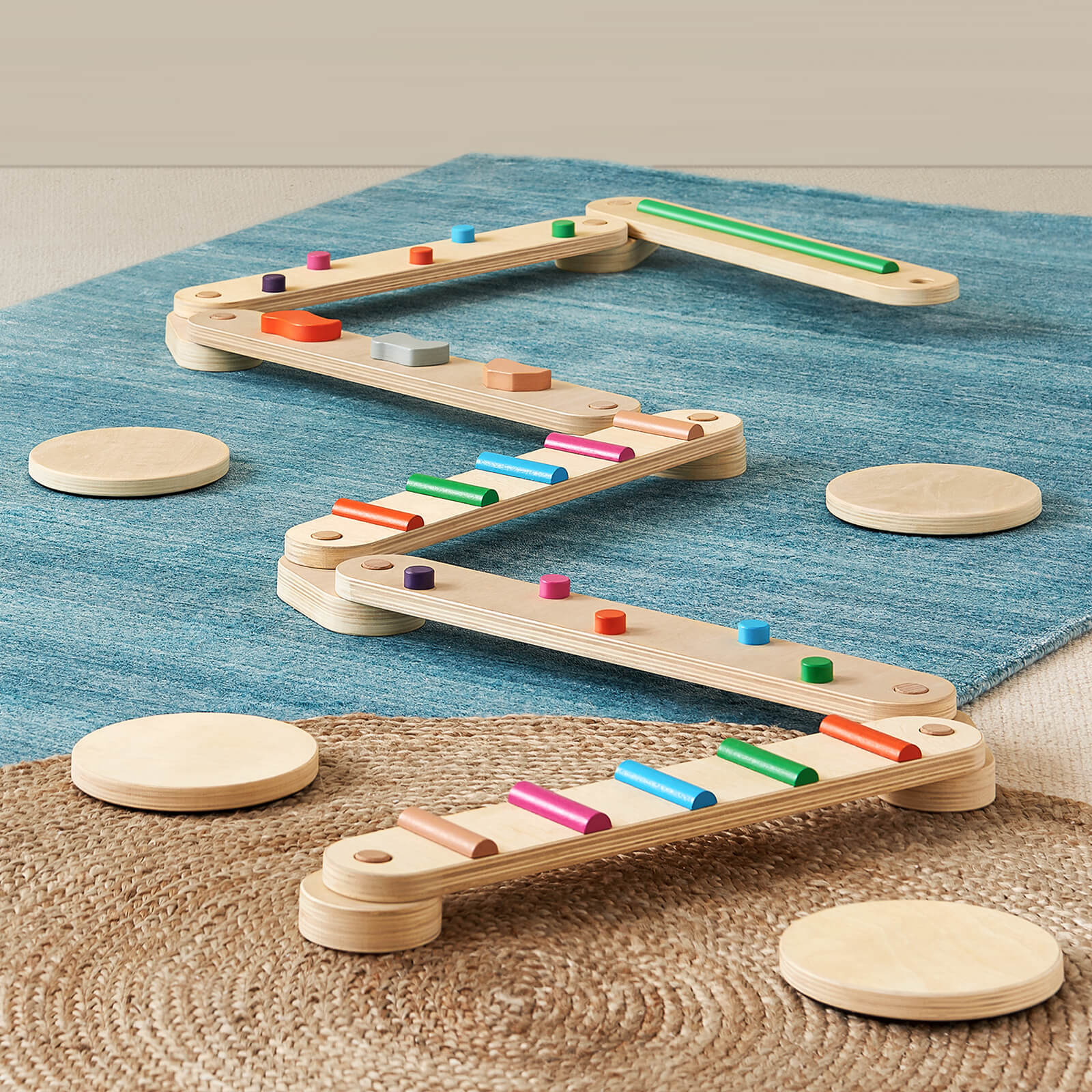 Wooden marble run toy with colorful marbles on a textured surface