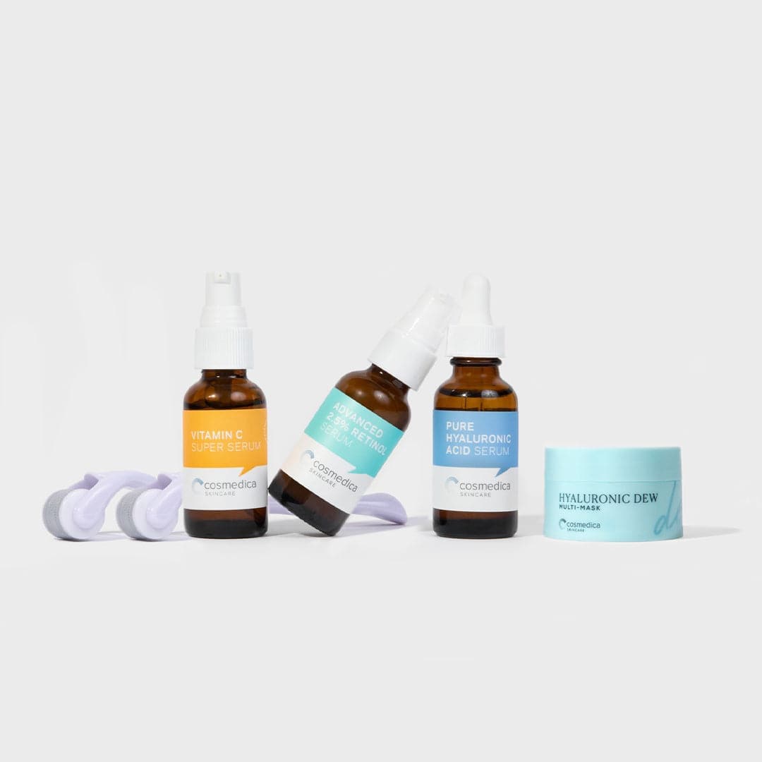 Set of skincare products including bottles and a jar on a light background
