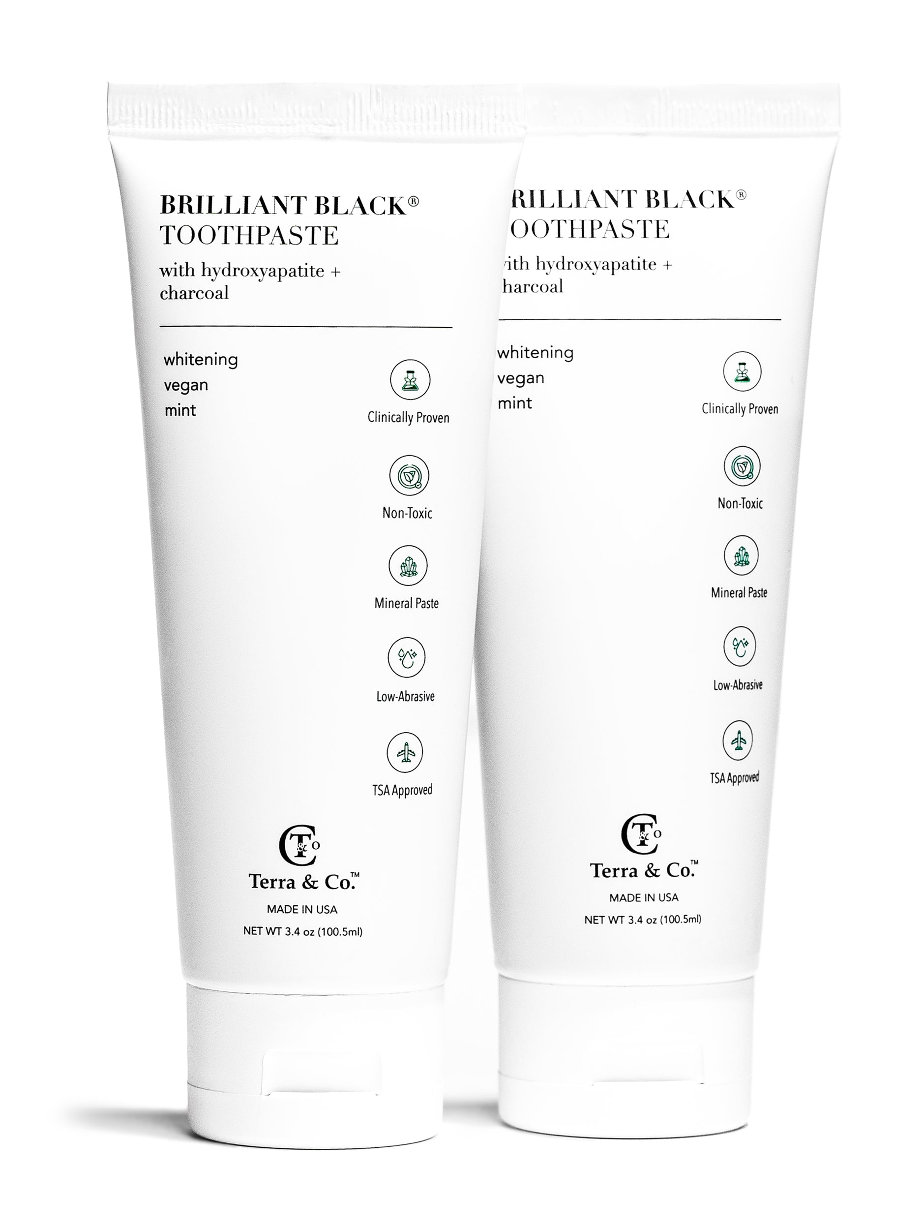 Two tubes of Brilliant Black toothpaste with Terra & Co. branding on a white background.