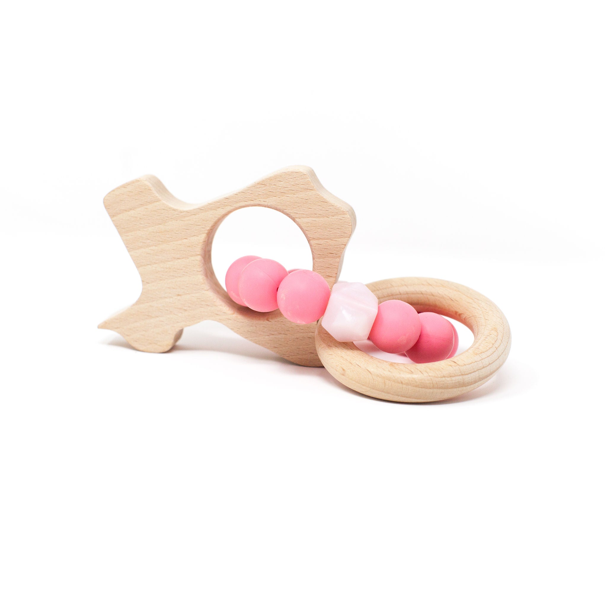 Wooden teething ring with pink and white beads on a white background