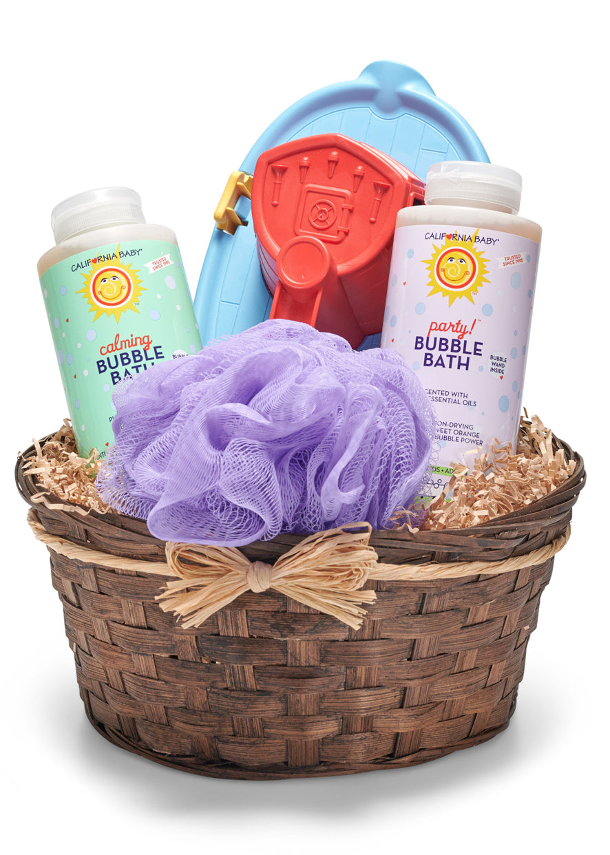 Bath time gift basket with bubble bath, loofah, and toys on a white background