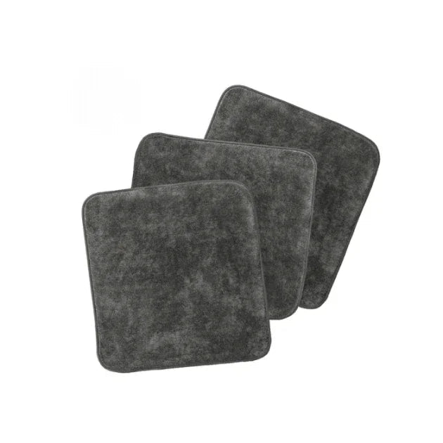 Three gray square coasters on a white background