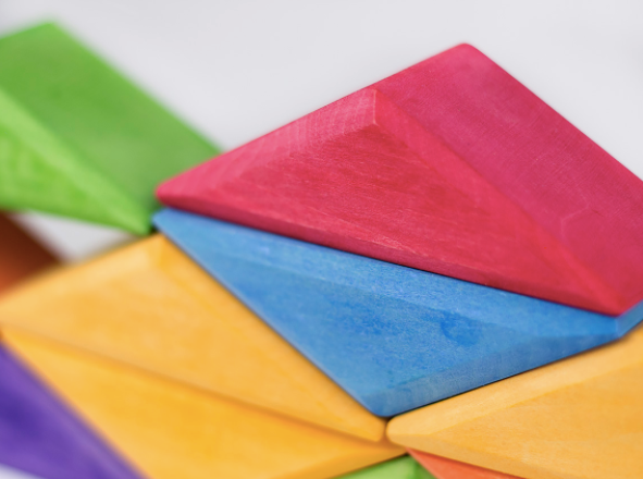 Colorful geometric wooden blocks on a white background