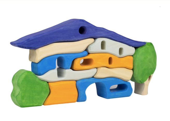 Colorful wooden puzzle toy with a blue roof, orange base, and green trees on a white background