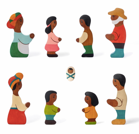 Set of wooden figurines representing a family on a white background