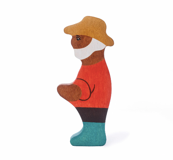 Wooden bear figurine wearing a red sweater, brown hat, and blue shoes on a white background