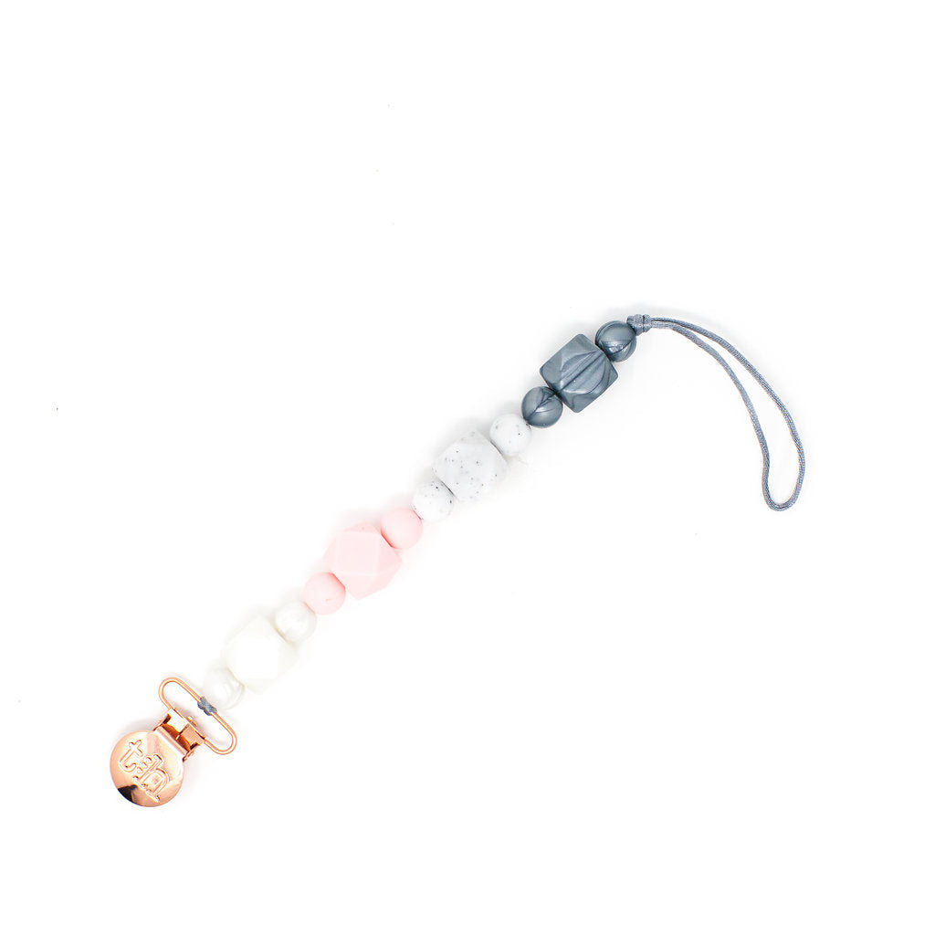 Mam_INITIALIZER with rose gold, pink, and gray beads on a white background