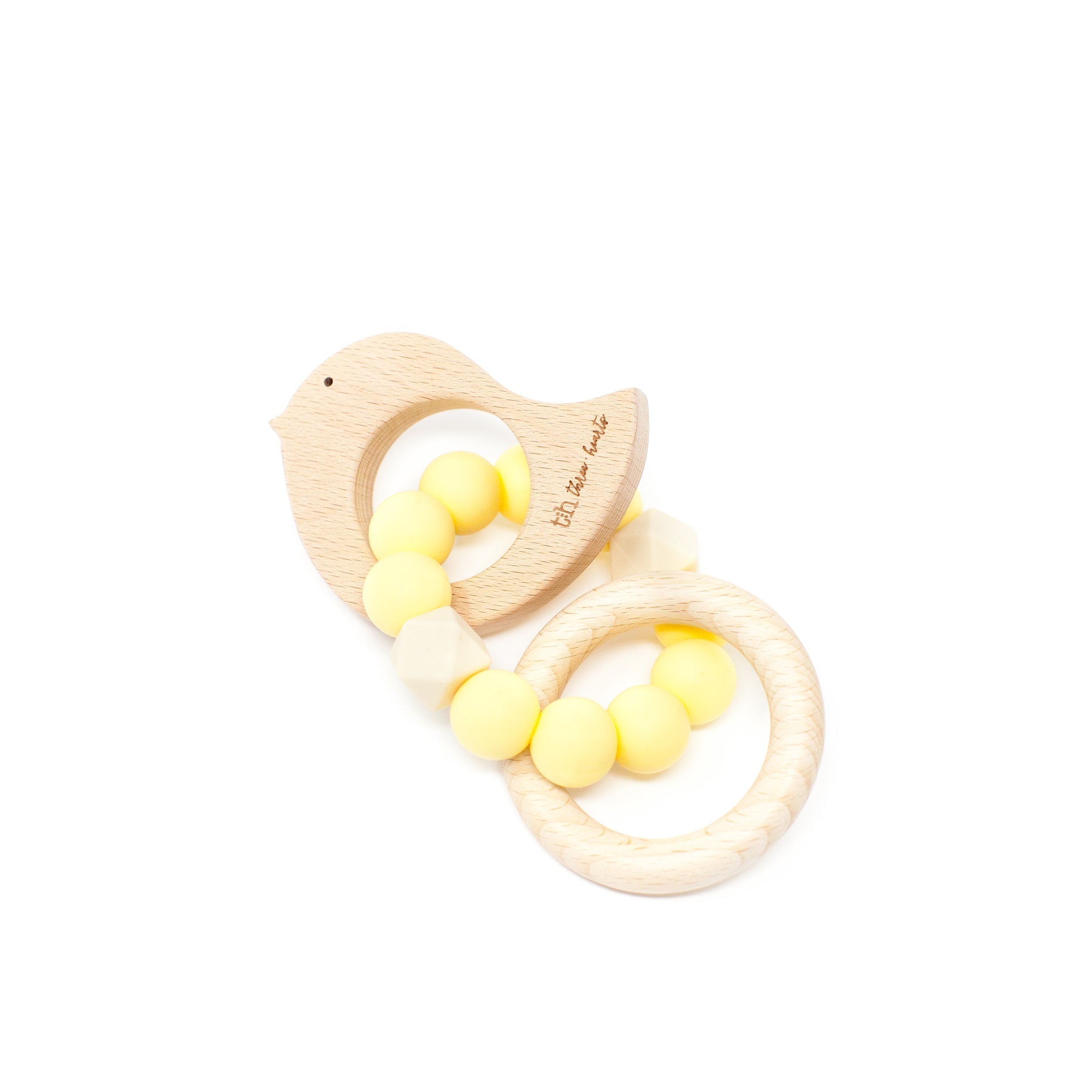 Wooden teething ring with yellow beads on a white background