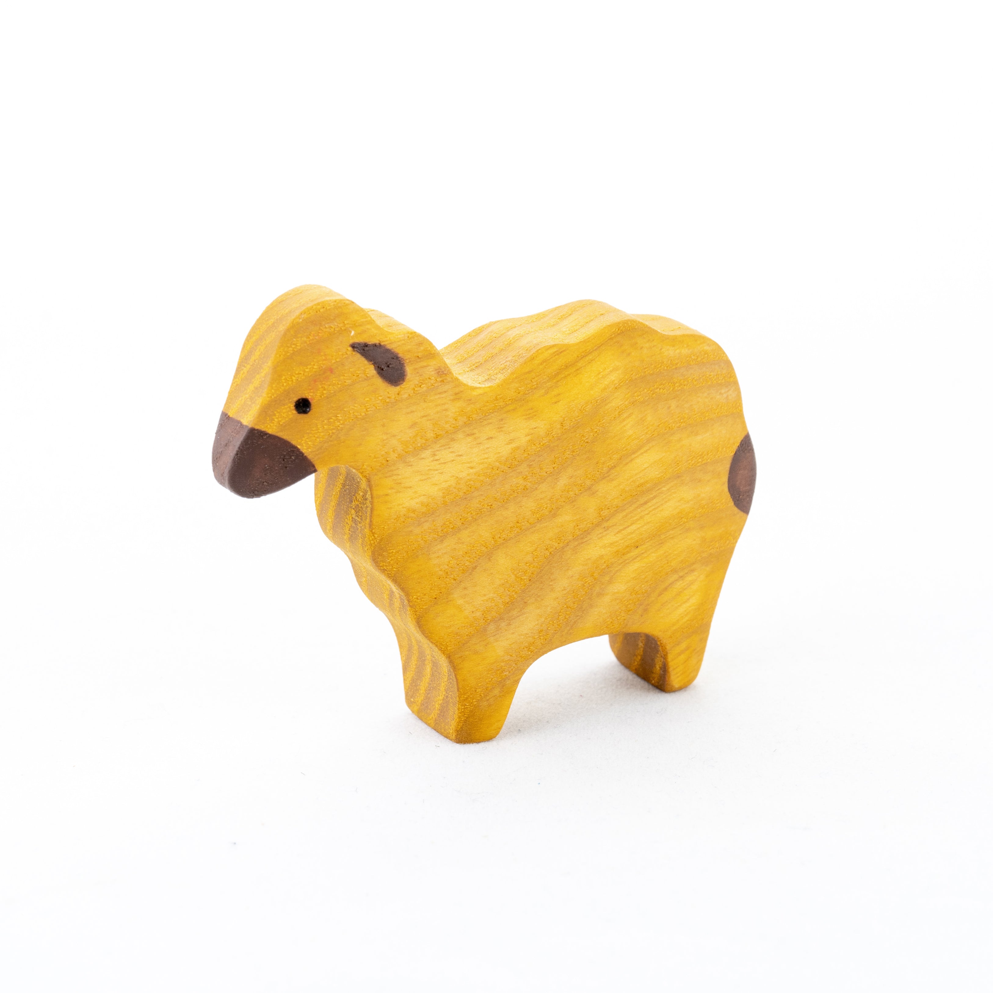 Wooden sheep figurine on a white background