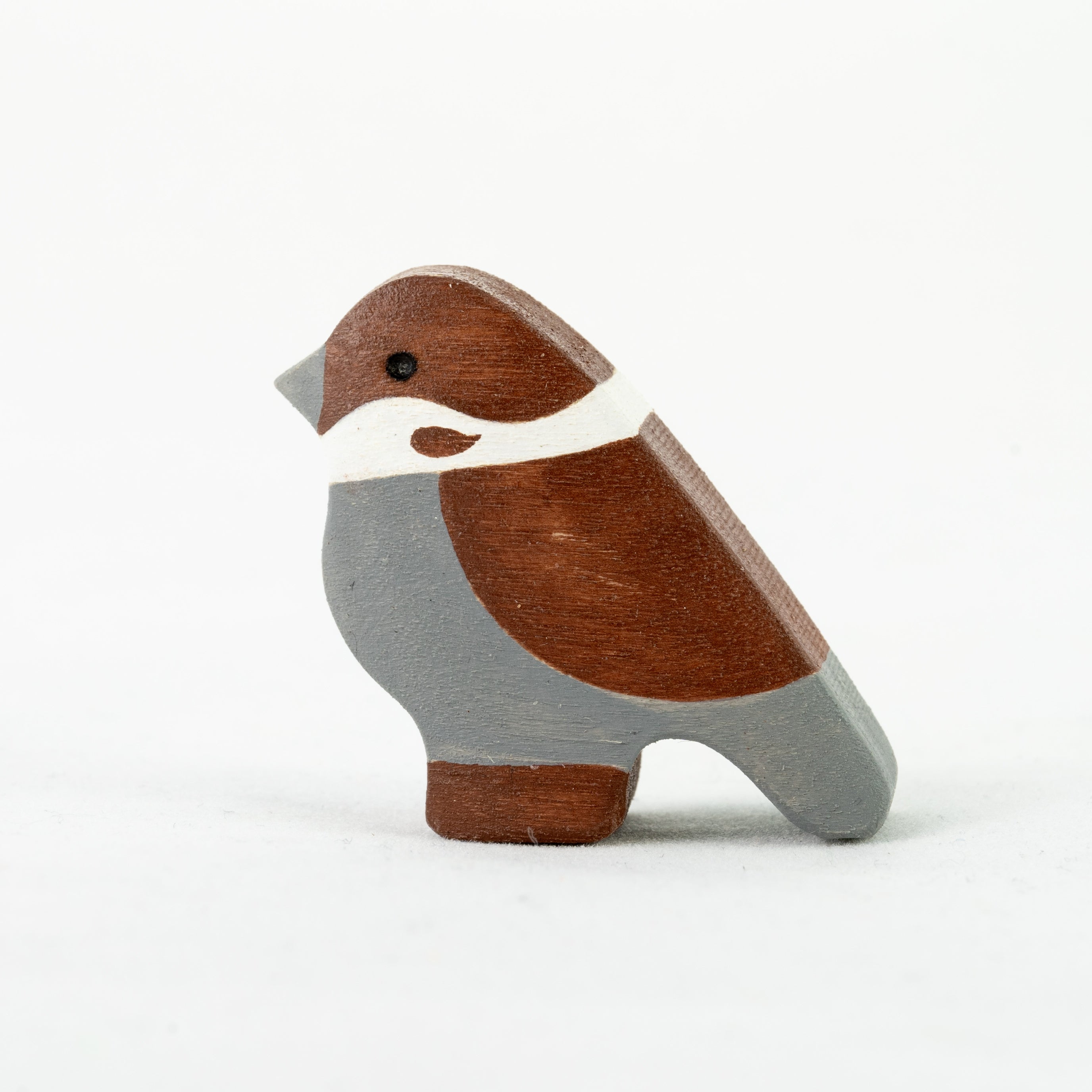 Wooden bird figurine on a white background