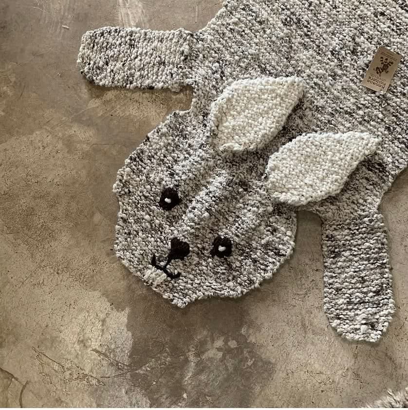 Knitted bunny hat on a textured surface