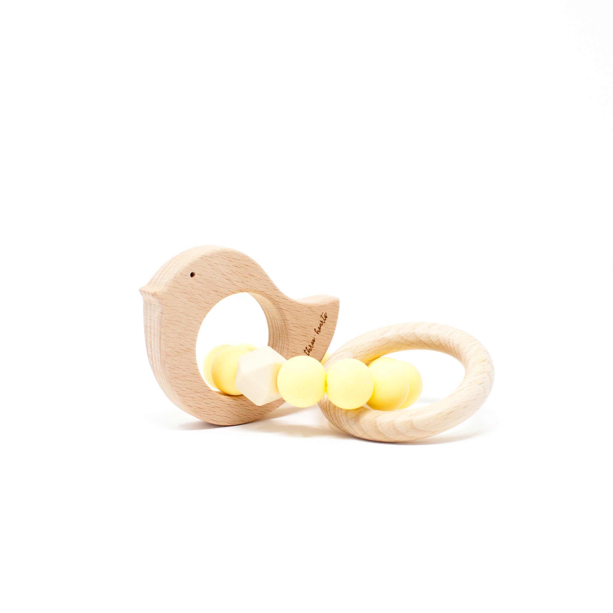 Wooden bird-shaped teething ring with yellow beads on a white background