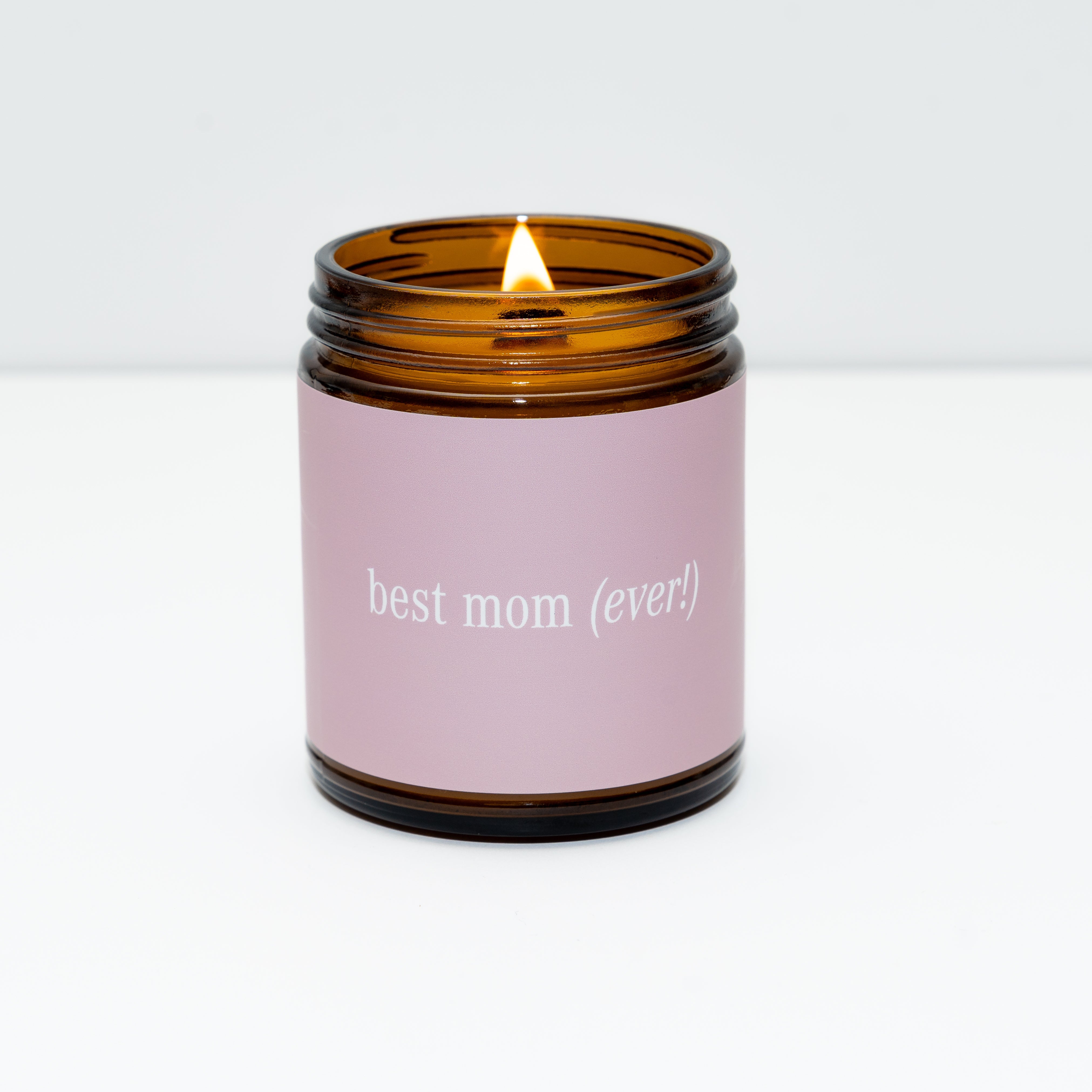 Candle in an amber jar with a pink label reading 'best mom (ever)!'