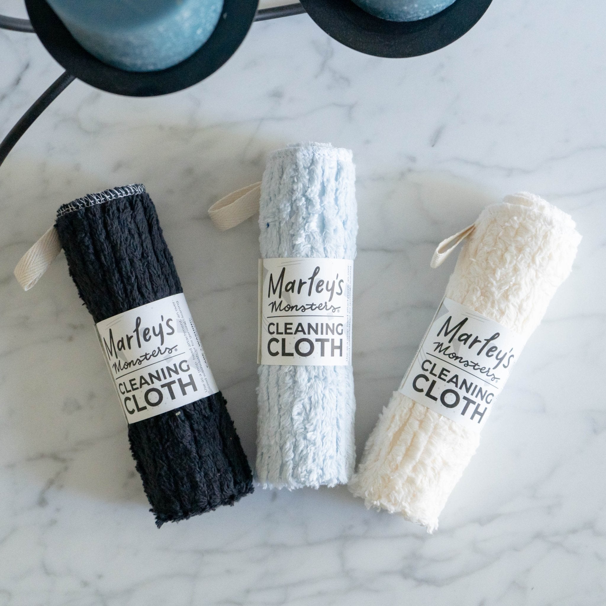 Three Marley's Monsters cleaning cloths on a marble surface