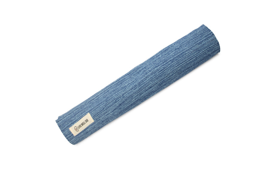 Blue knitted headband with a brand label on a white background