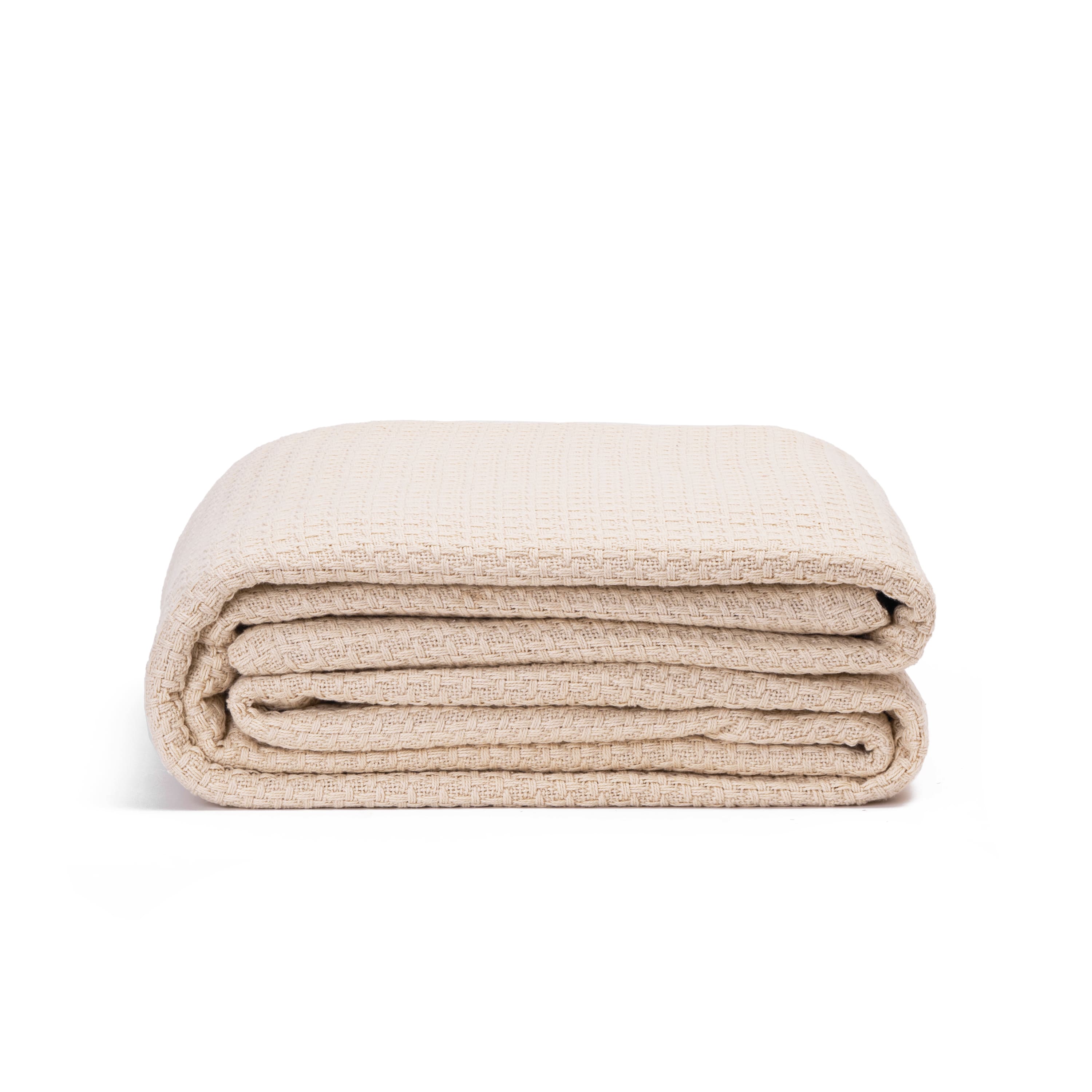 Folded beige blanket on a white background