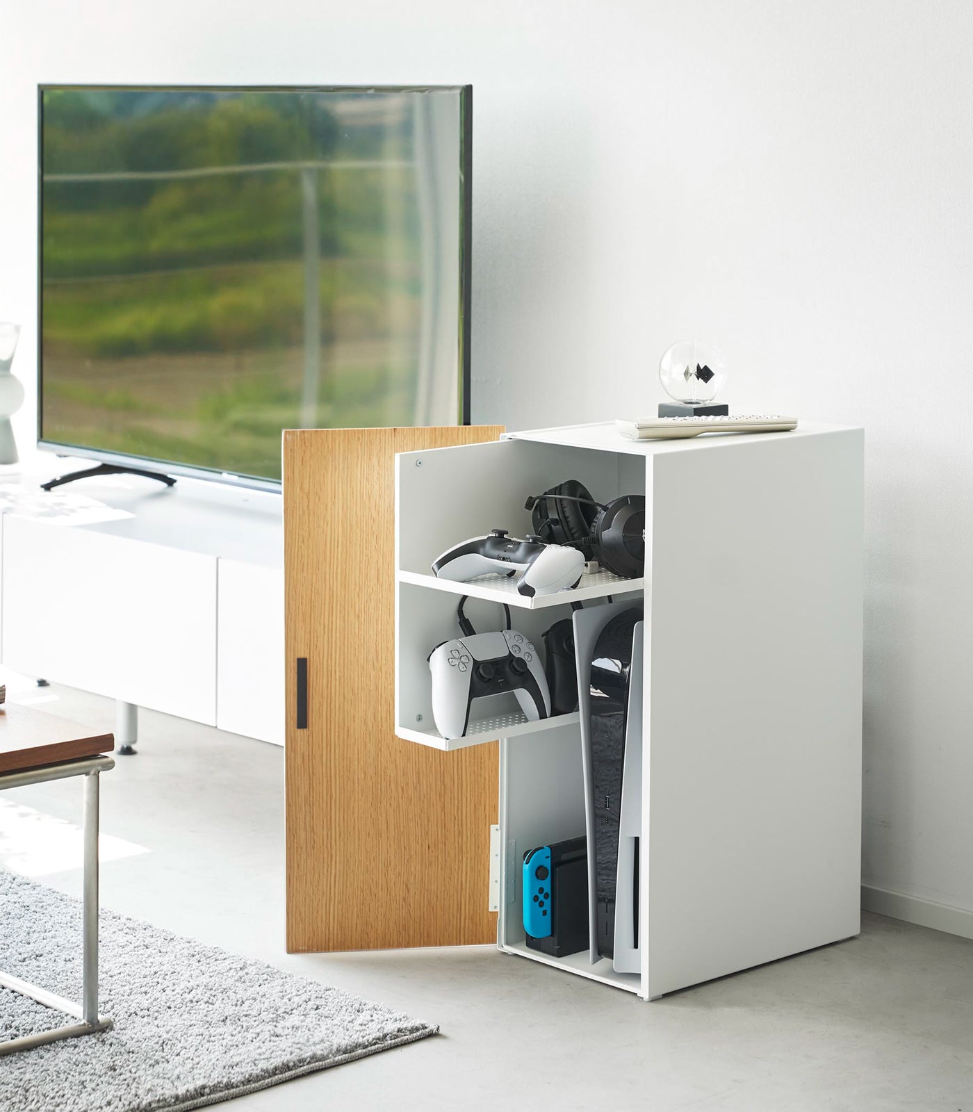 Modern office setup with a white desk and wooden cabinet in a minimalistic room.