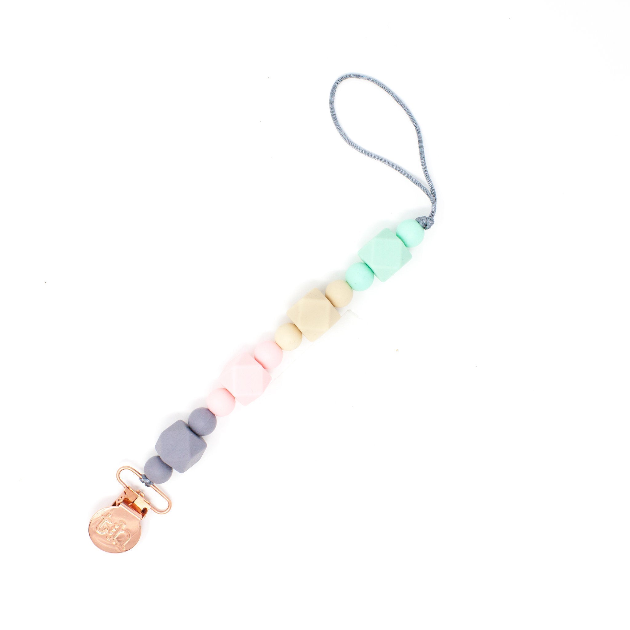 Colorful pacifier clip with a small gold bell on a white background