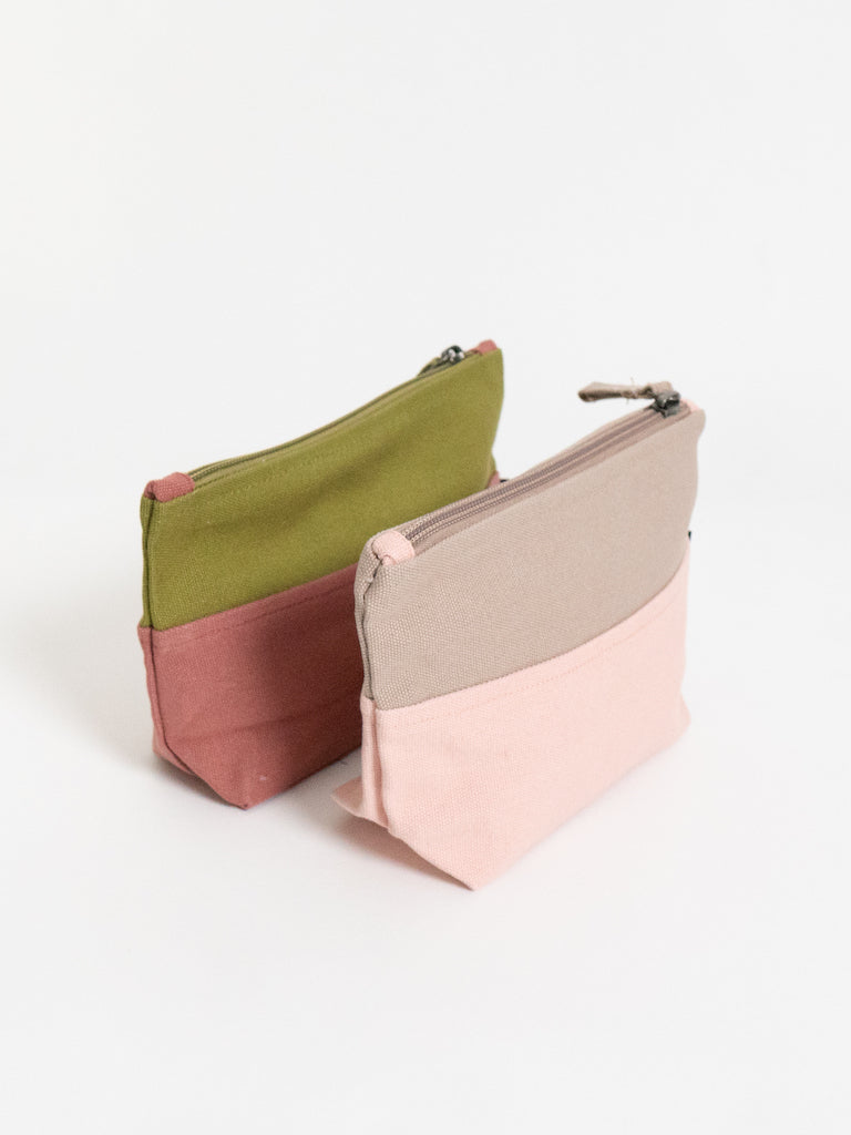 Two fabric pouches in green, pink, and beige on a white background