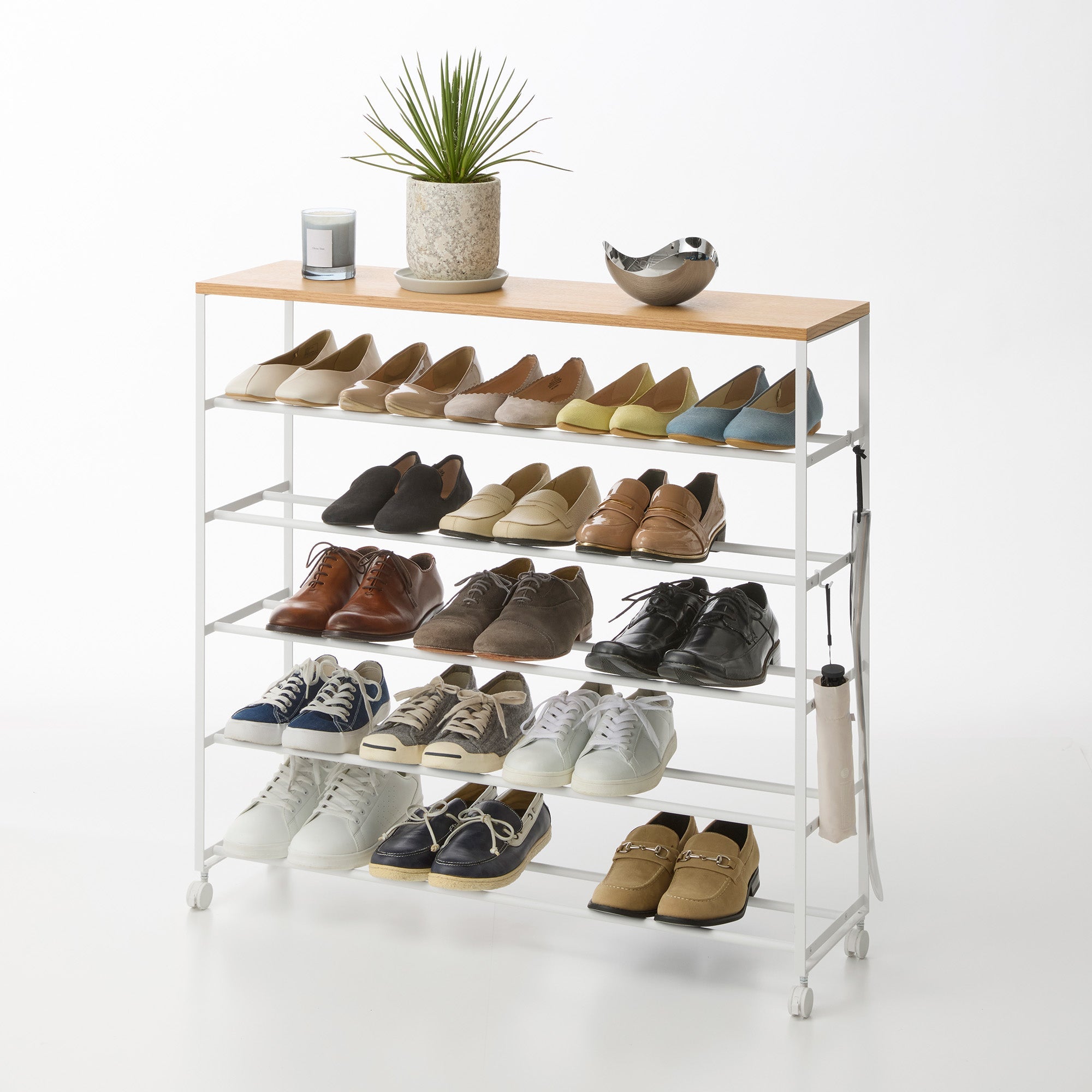 Shoe rack with various shoes on a white background