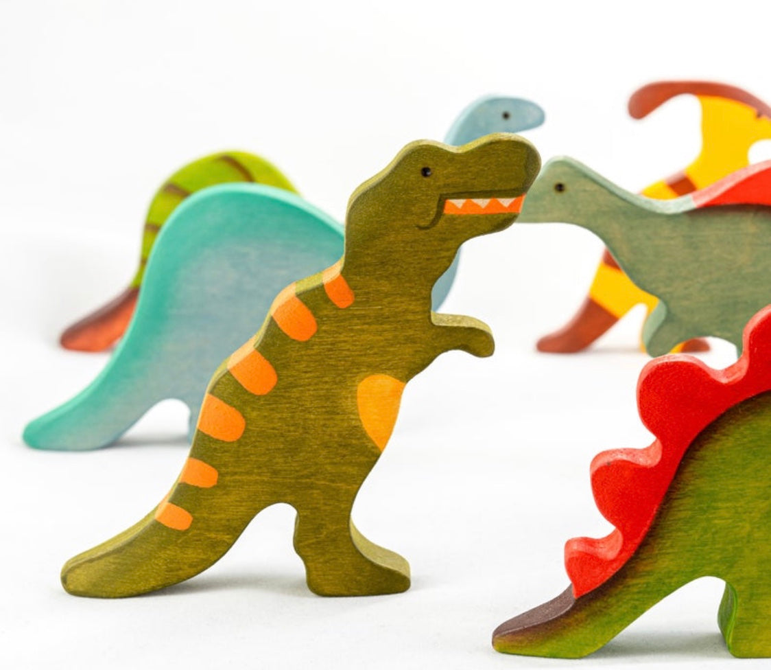 Colorful wooden dinosaur toys on a white background