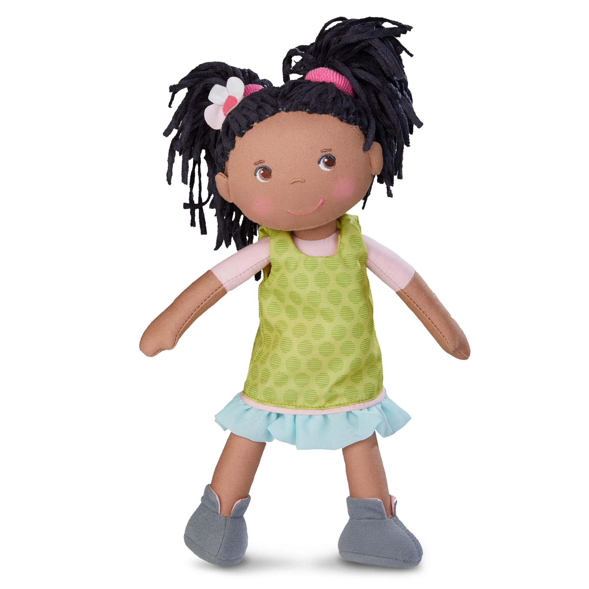 Doll with black hair styled in pigtails, wearing a green dress with a pink shirt and blue skirt on a white background.