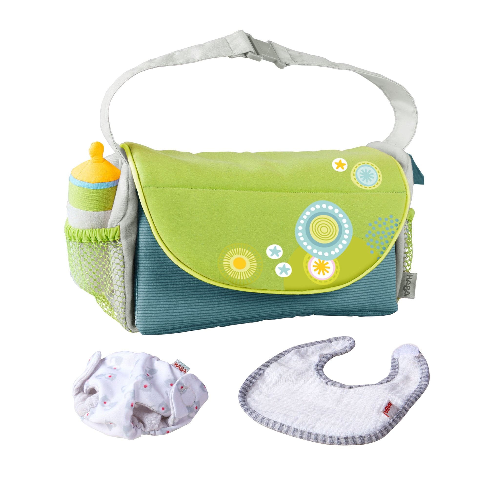 Green and blue diaper bag with baby items on a white background