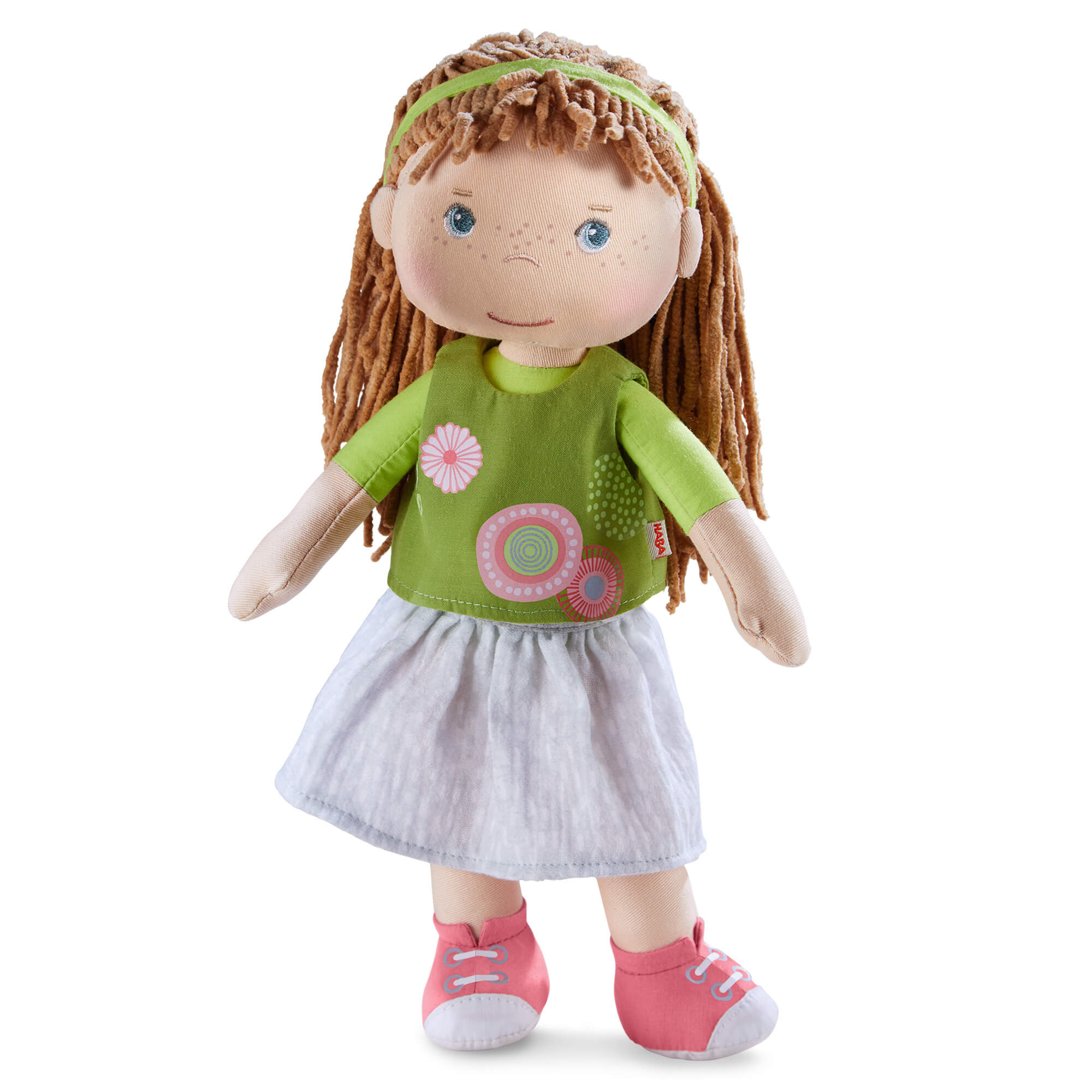 Doll with green shirt and white skirt on a white background
