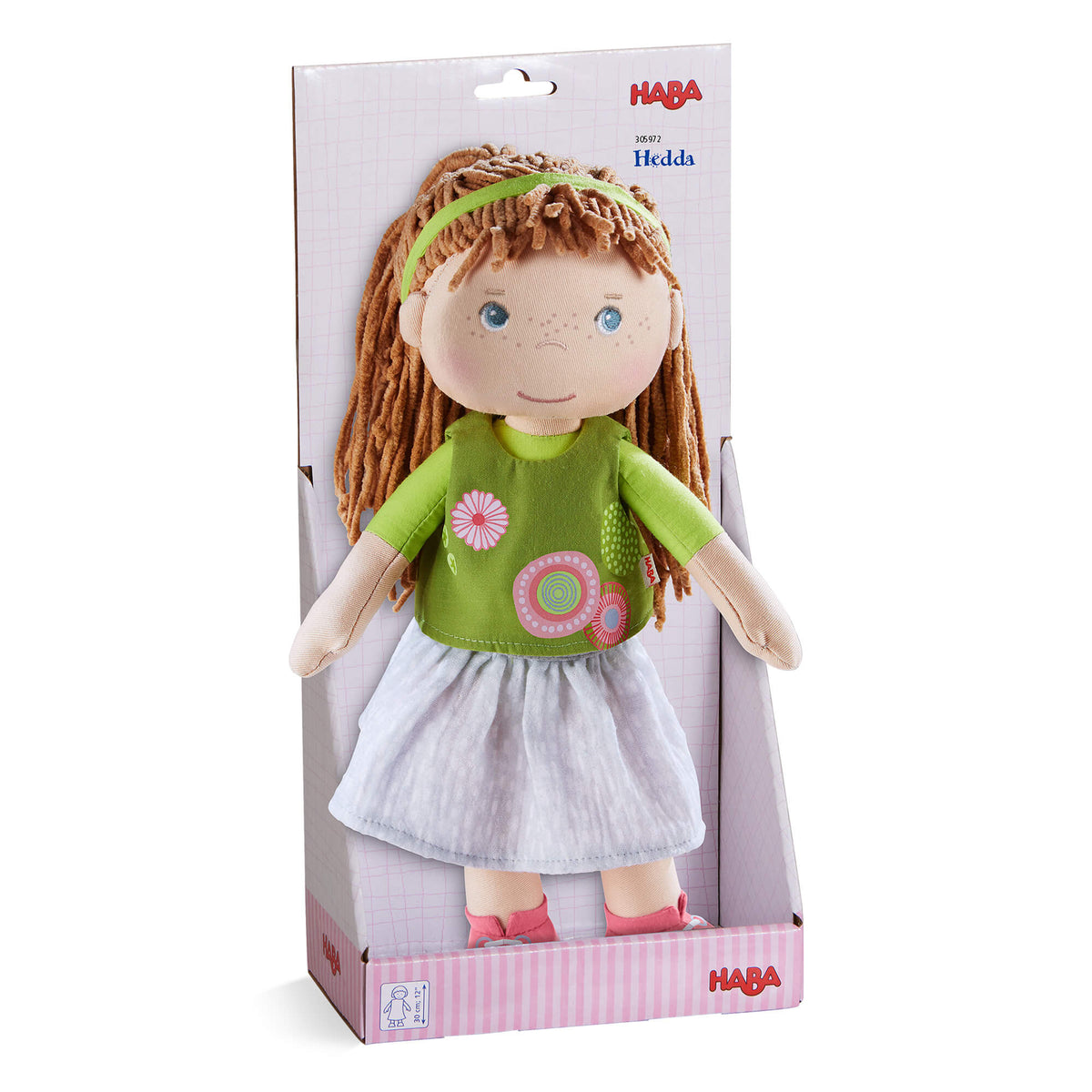 HABA doll packaging with a doll wearing a green shirt and white skirt on a white background