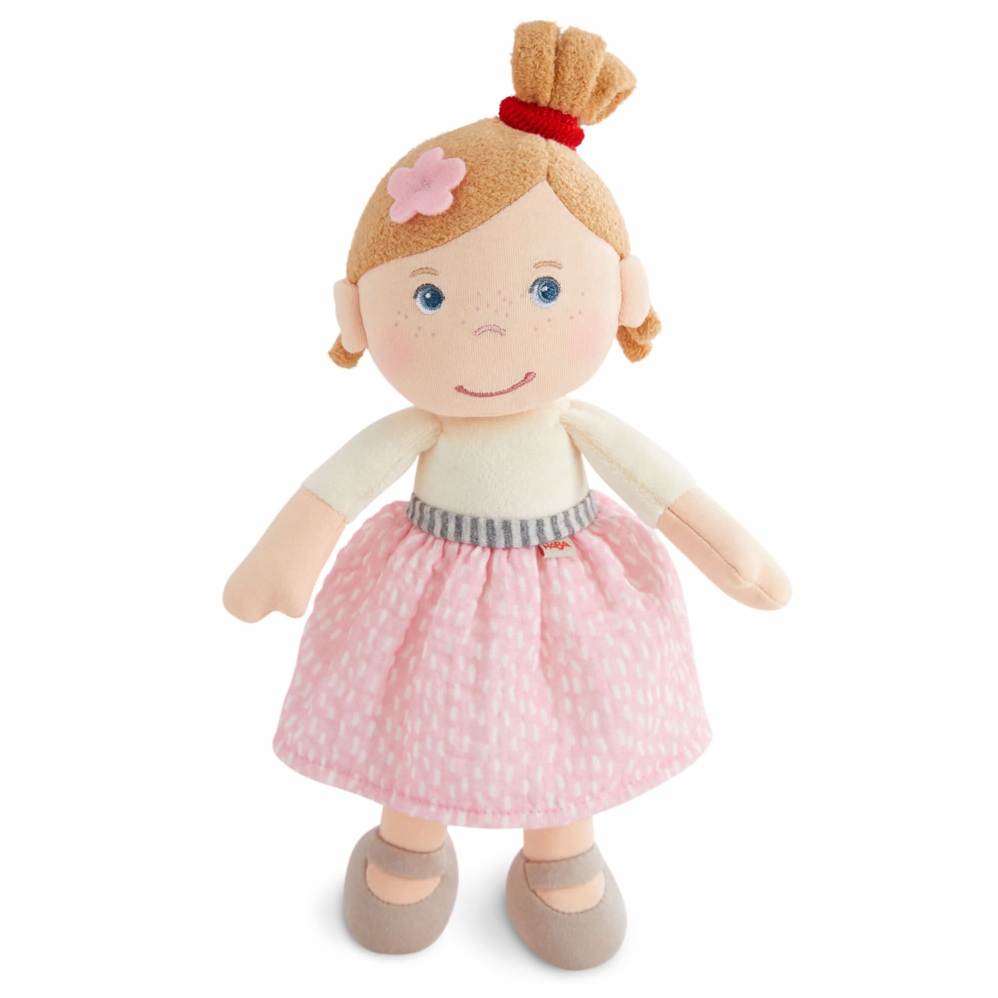 Plush toy doll with blonde hair, pink dress, and blue eyes on a white background