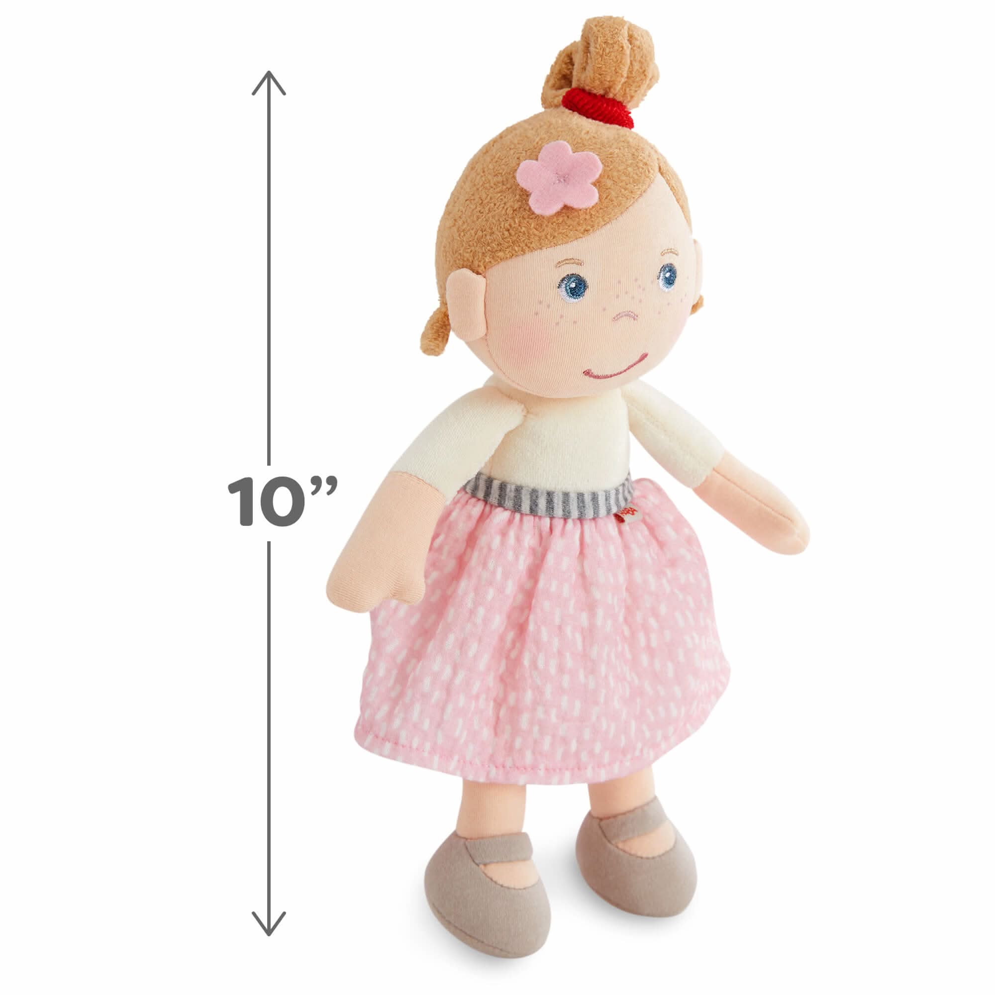 Plush doll with a pink skirt and measurement label on a white background