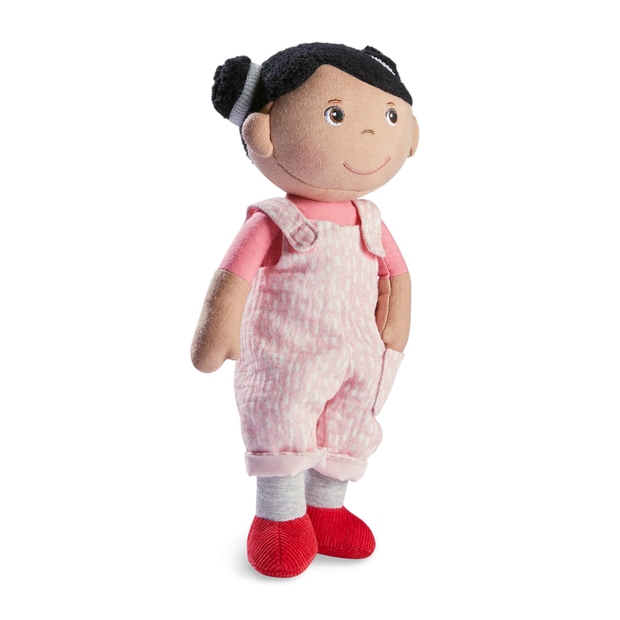 Stuffed doll with pink outfit on a white background