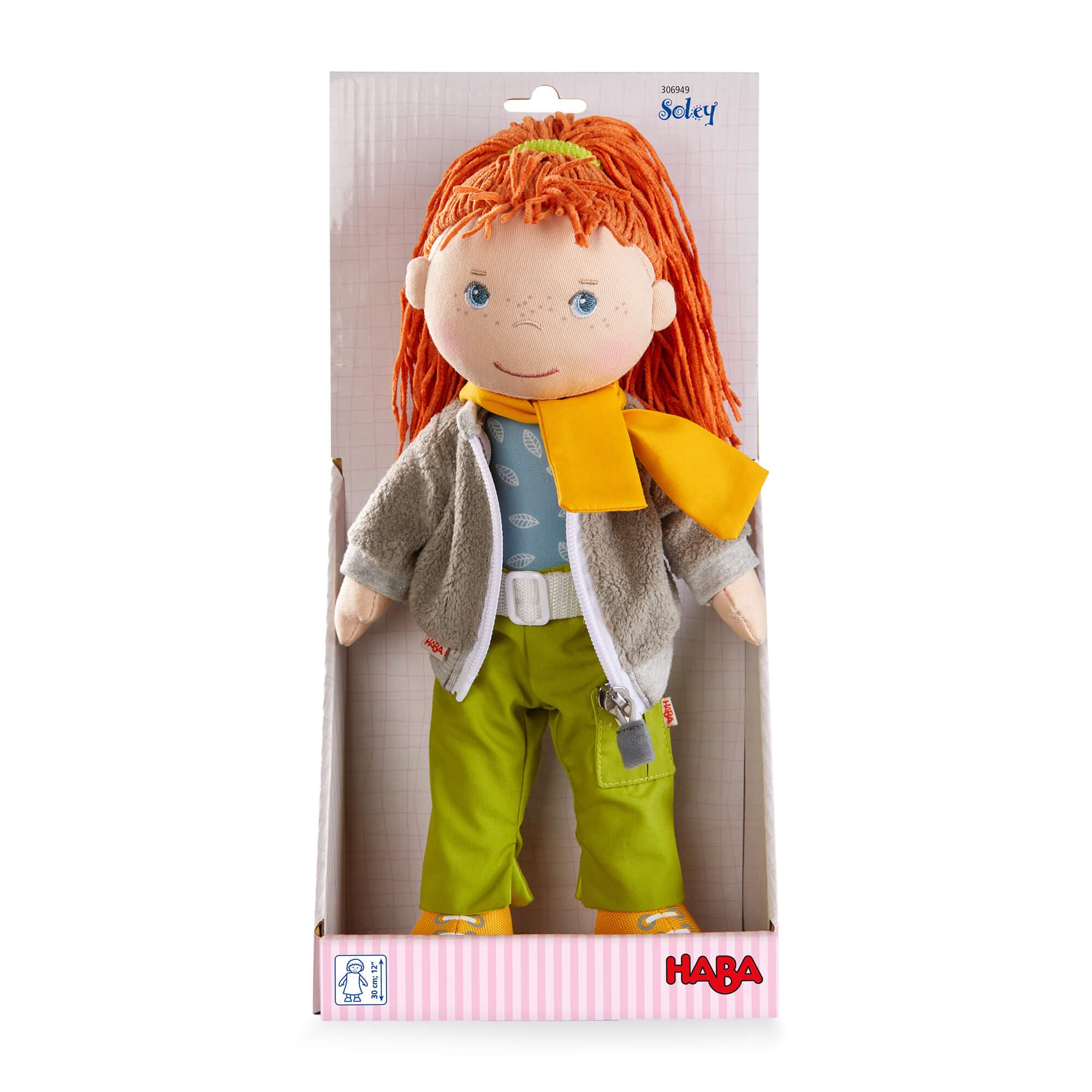 Plush doll with red hair and a yellow scarf in HABA packaging